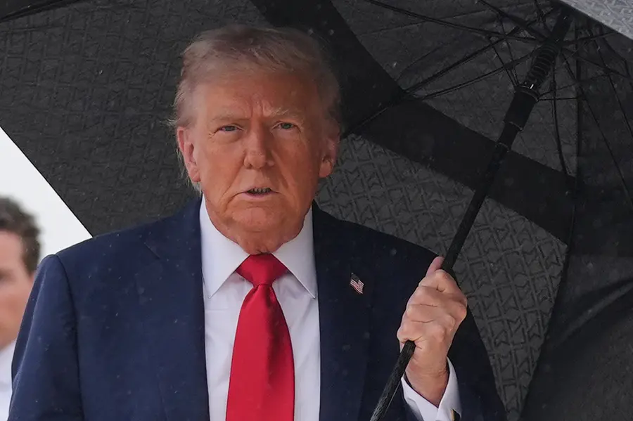 President Donald Trump walks over to speak with reporters before boarding Air Force One