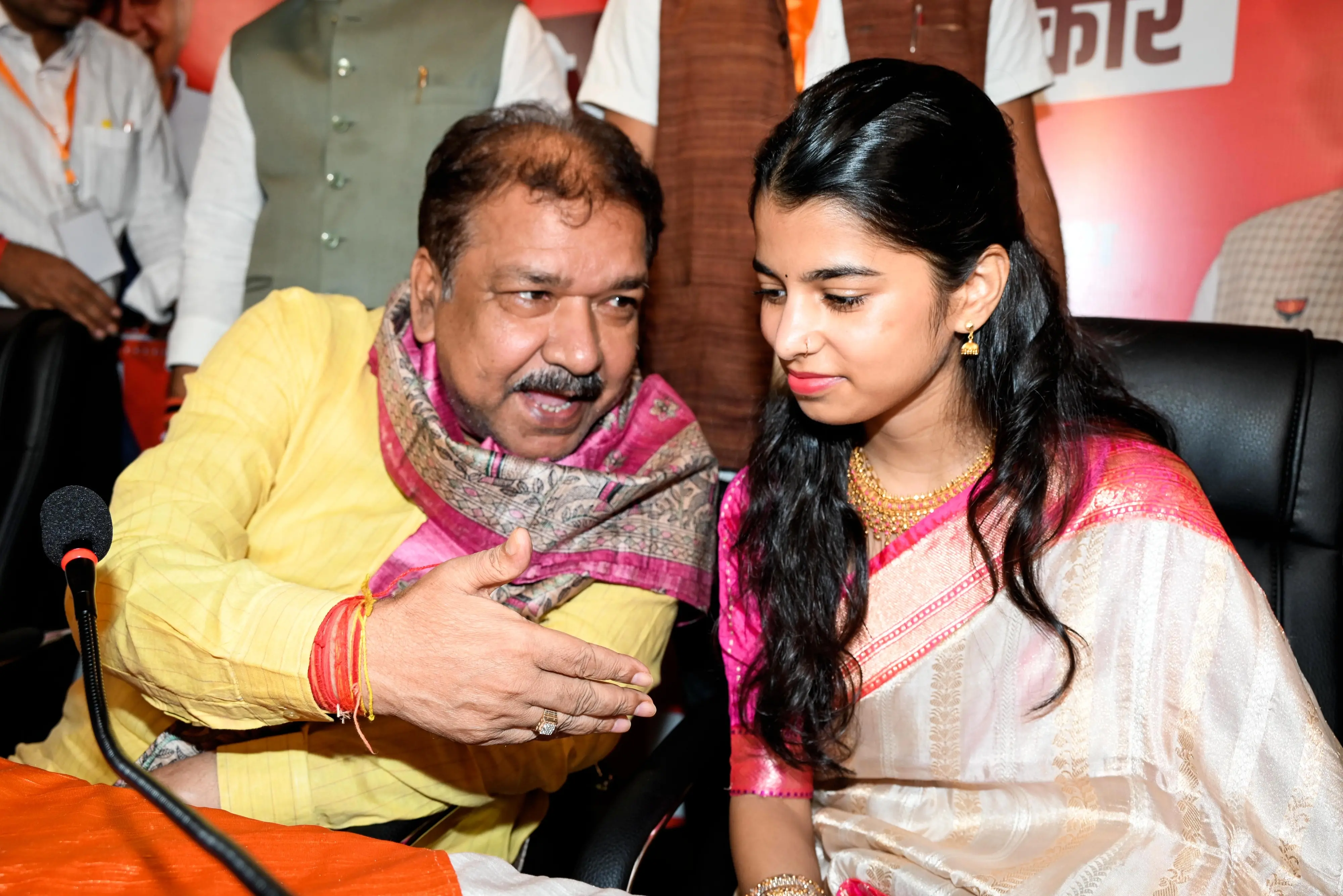BJP Bihar President Dilip Jaishwal interacts with playback singer Maithili Thakur as she joins the party during Milan Samaroh, in Patna on Tuesday. | Photo: PTI