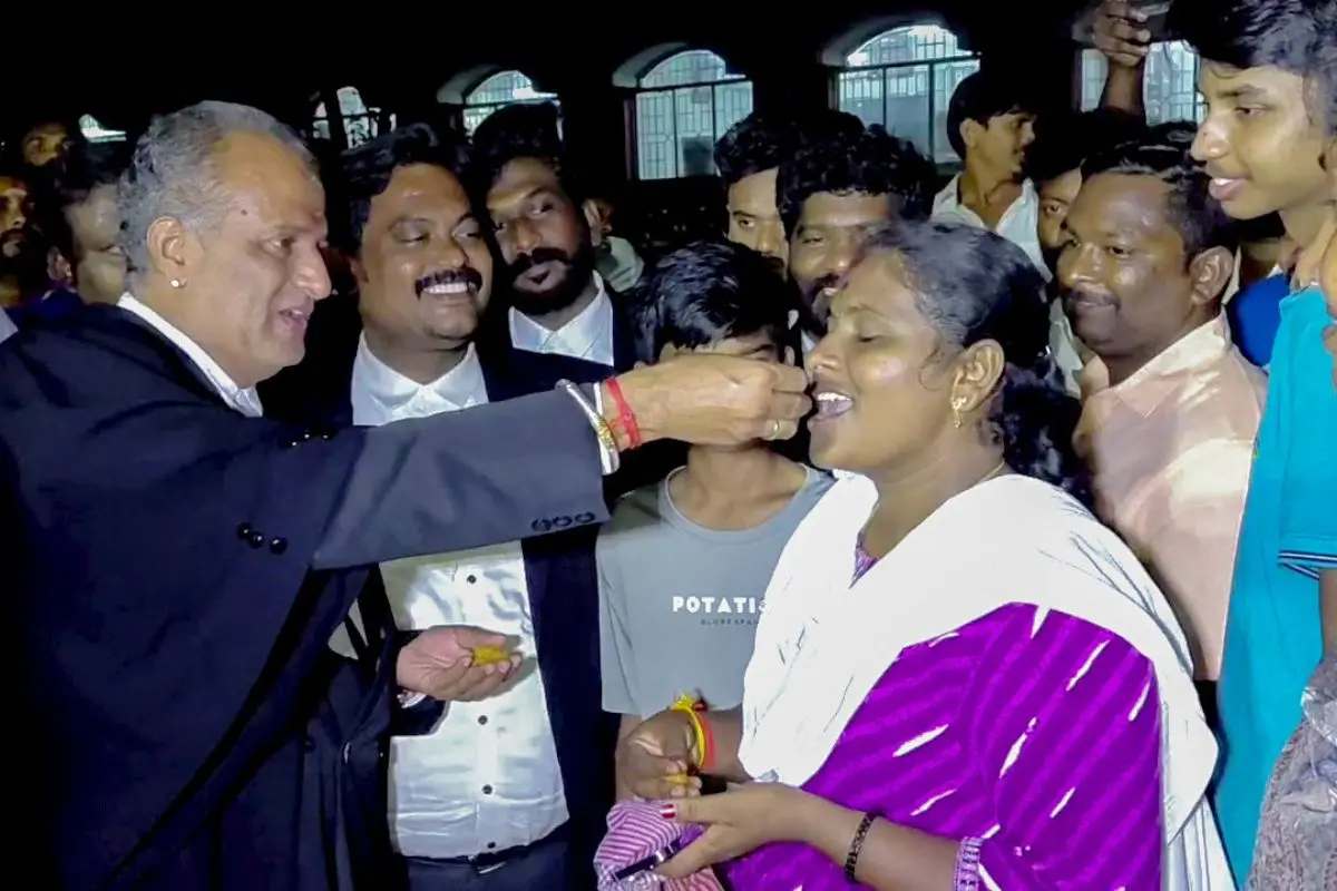 TVK members and families celebrate with sweets as the TVK Karur District Secretary Madhiyazhagan and Pownraj are to be released from jail in the Karur stampede case (Photo: ANI)