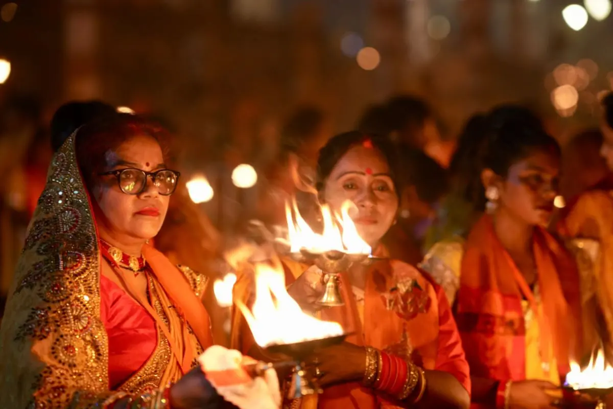 Hindu devotees carry lamps as they pray on the banks of the Saryu river during Deepotsav celebrations, on the eve of Deepotsav, in Ayodhya | Photo: AP