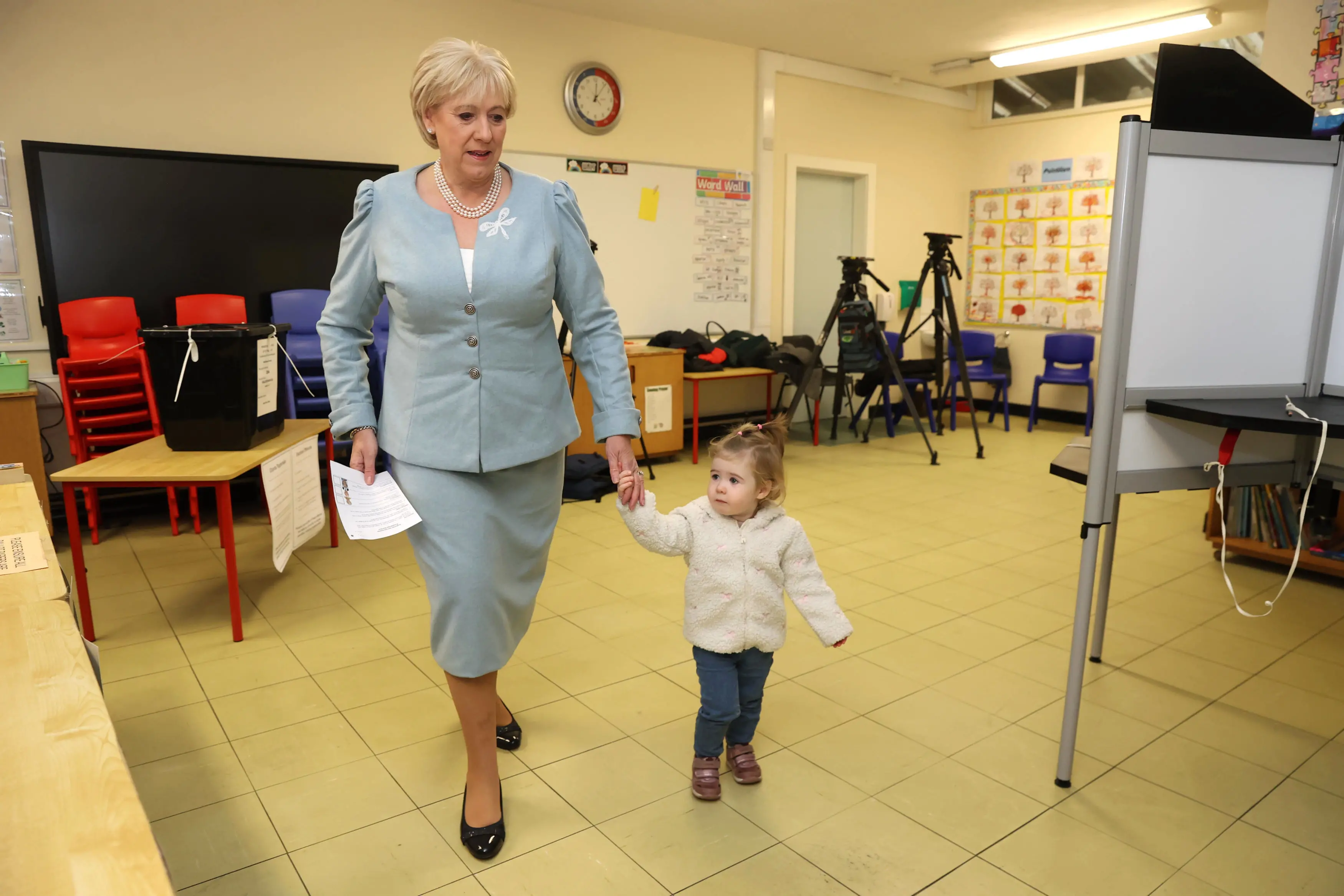 Fine Gael candidate Heather Humphreys casts her vote with the help of her one-year-old grandaughter Charlotte at Killeevan Central National School in Newbliss, Co Monaghan, for the election for the next Irish president. | Photo: AP