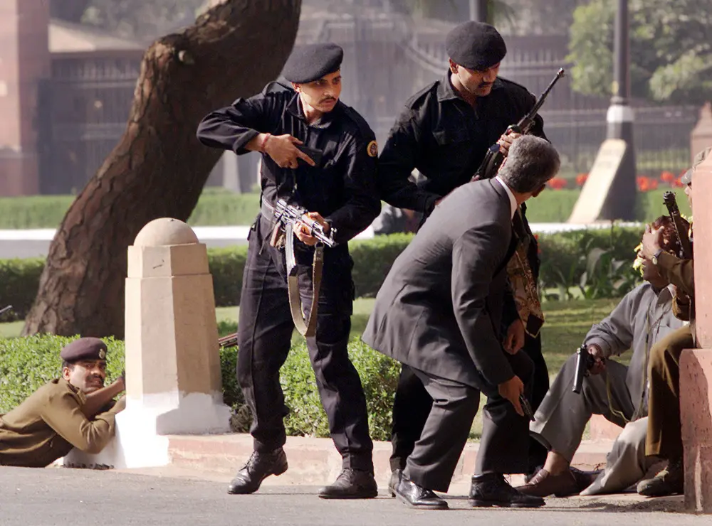 Indian commandoes escort civilians outside the Parliament after gunmen attack | AP File