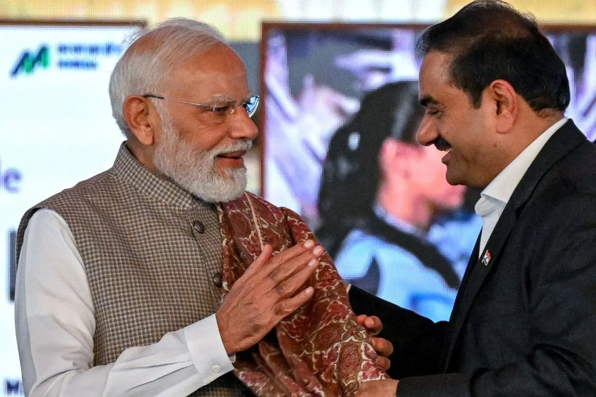 India's Prime Minister Narendra Modi (L) greets Gautam Adani, Chairperson of Indian conglomerate Adani Group | File photo: AFP