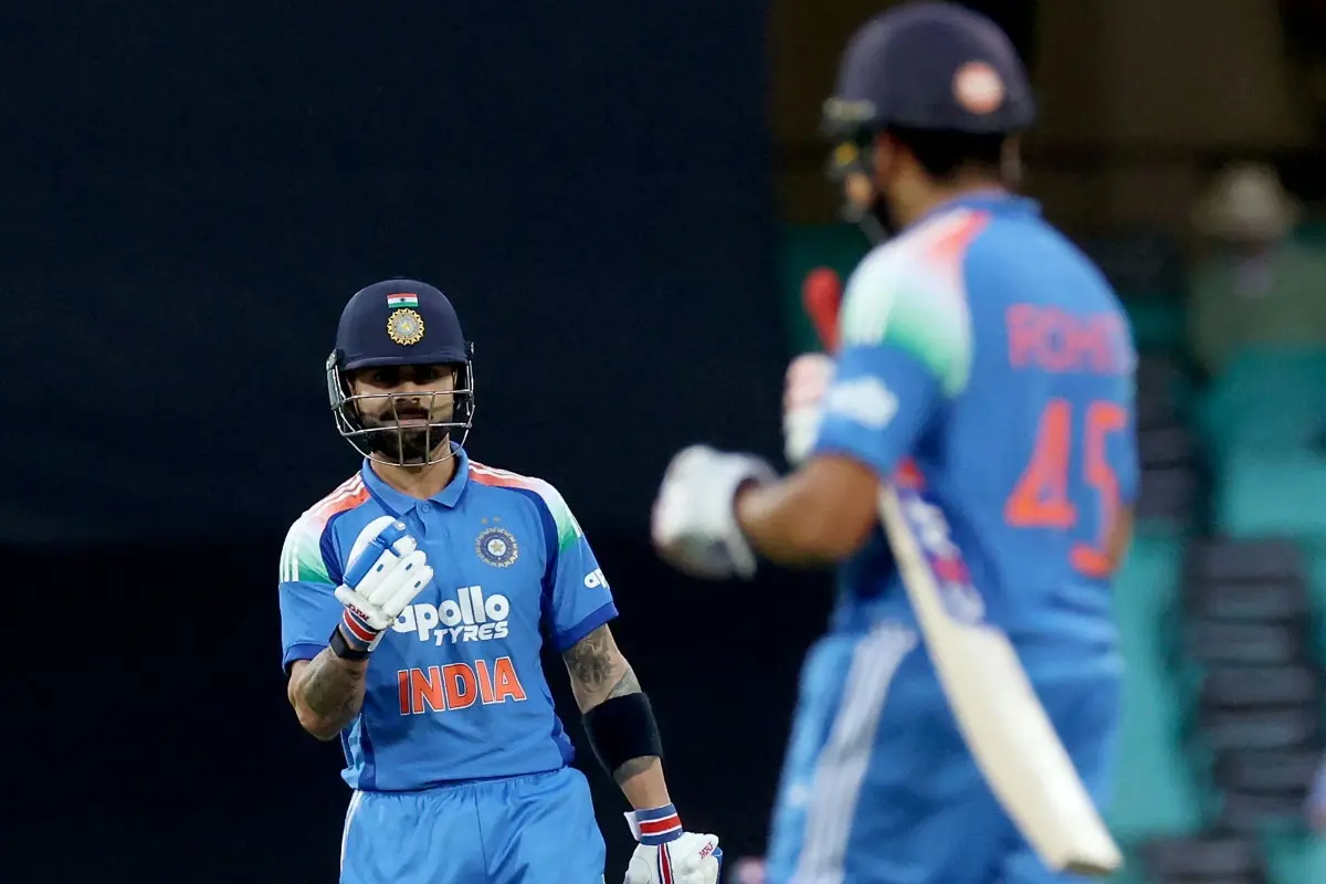 India's Virat Kohli (L) reacts towards teammate Rohit Sharma after making his first run during the third one-day international cricket match between Australia and India at the SCG in Sydney. | Photo: AFP