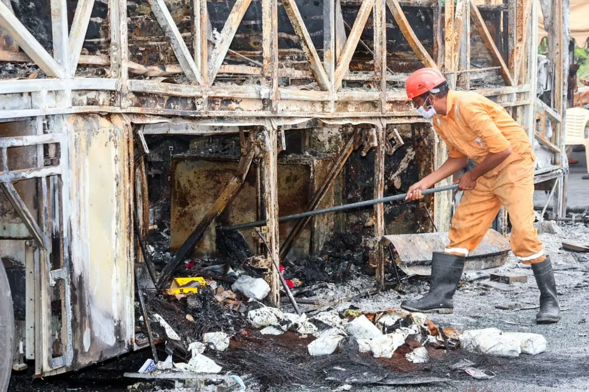 A member of the forensic team collecting samples from the spot after a bus caught fire | Photo: ANI