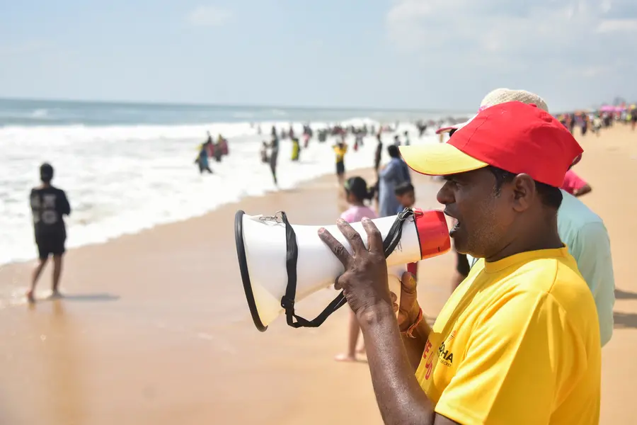 A lifeguard urges visitors not to venture too deep into the sea in view of 'Cyclone Montha'