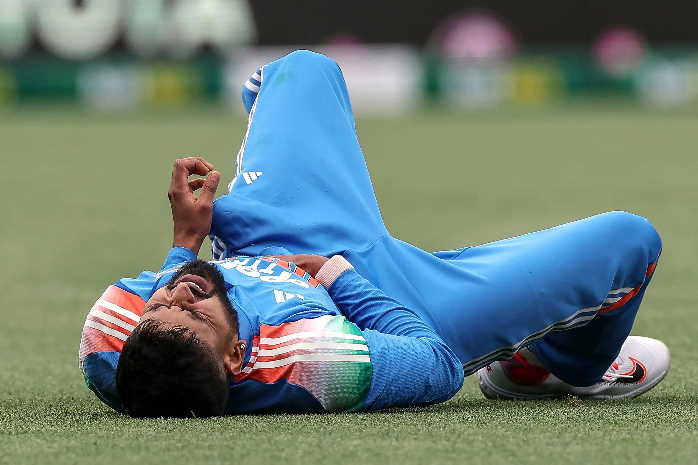 India's Shreyas Iyer reacts after falling on the ground while taking a catch to dismiss Australia's Alex Carey during the third one-day international (ODI) men's cricket match between Australia and India at the Sydney Cricket Ground in Sydney. | Photo: AFP