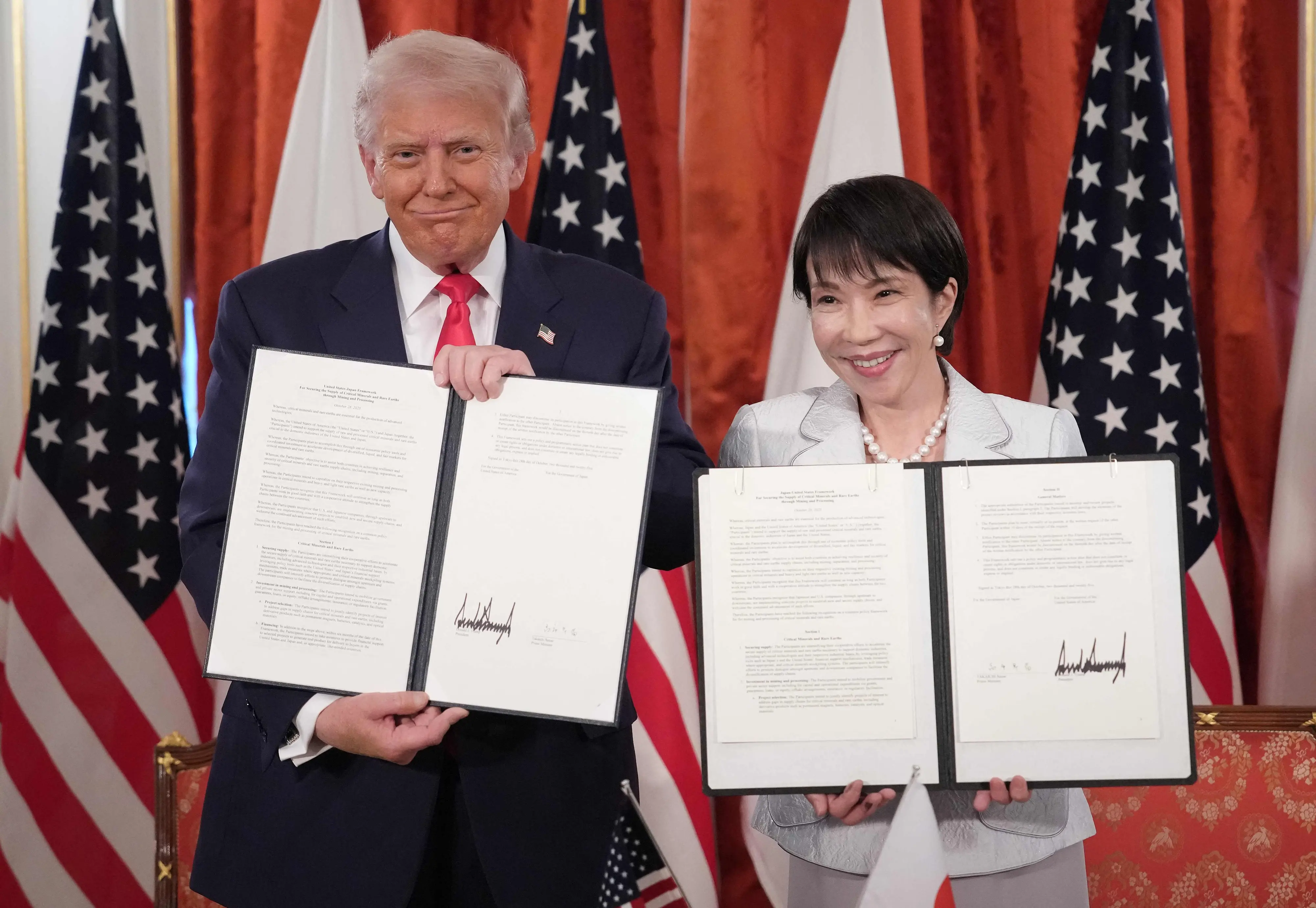 US President Donald Trump (L) and Japanese Prime Minister Sanae Takaichi (R) hold up signed documents for a critical minerals/rare earth deal with Japan during a meeting at Akasaka Palace | Photo: AFP