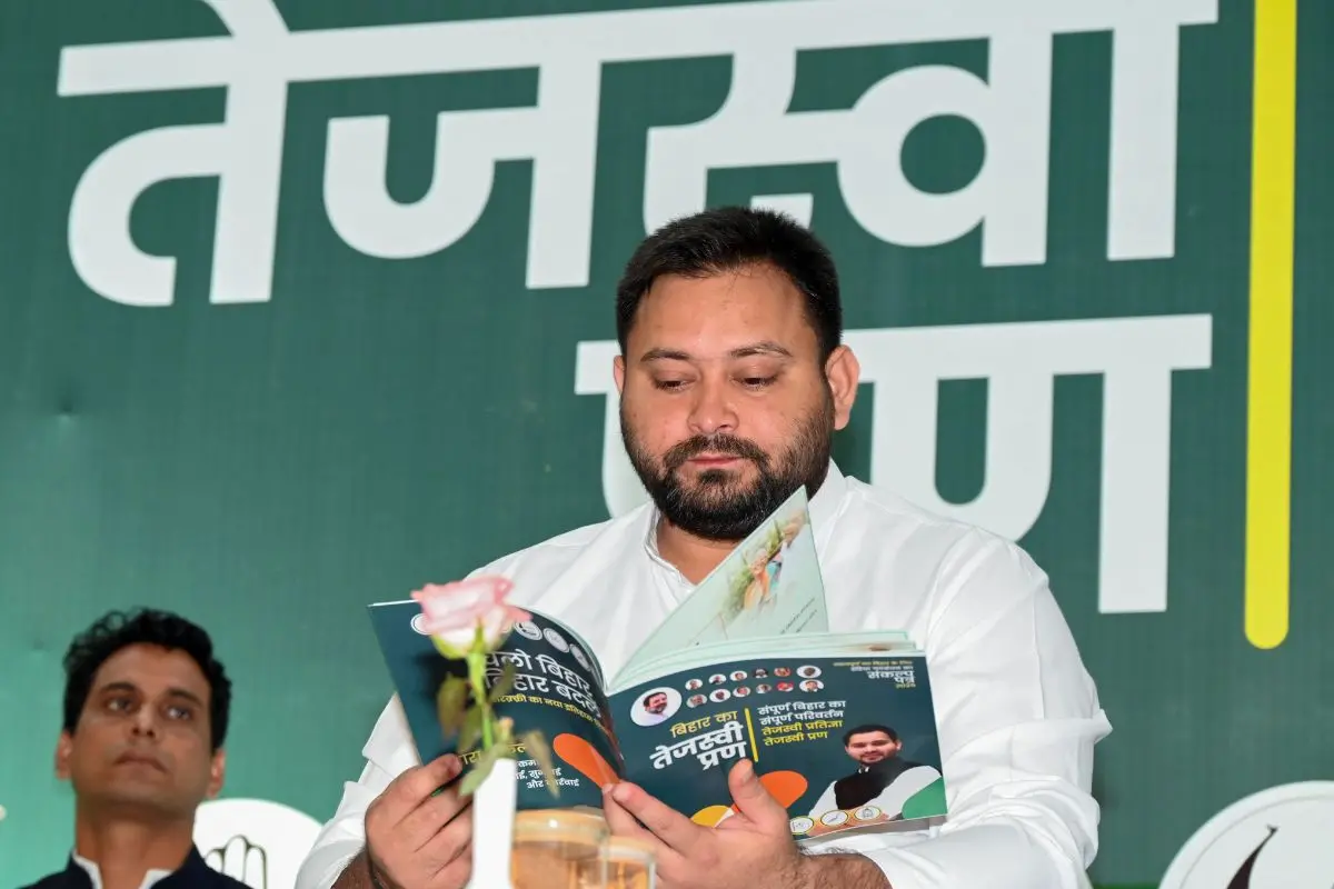 Rashtriya Janata Dal leader Tejashwi Yadav holds the Mahagathbandhan's manifesto (Tejaswi Pran) at a joint press conference of Mahagathbandhan | Photo: ANI