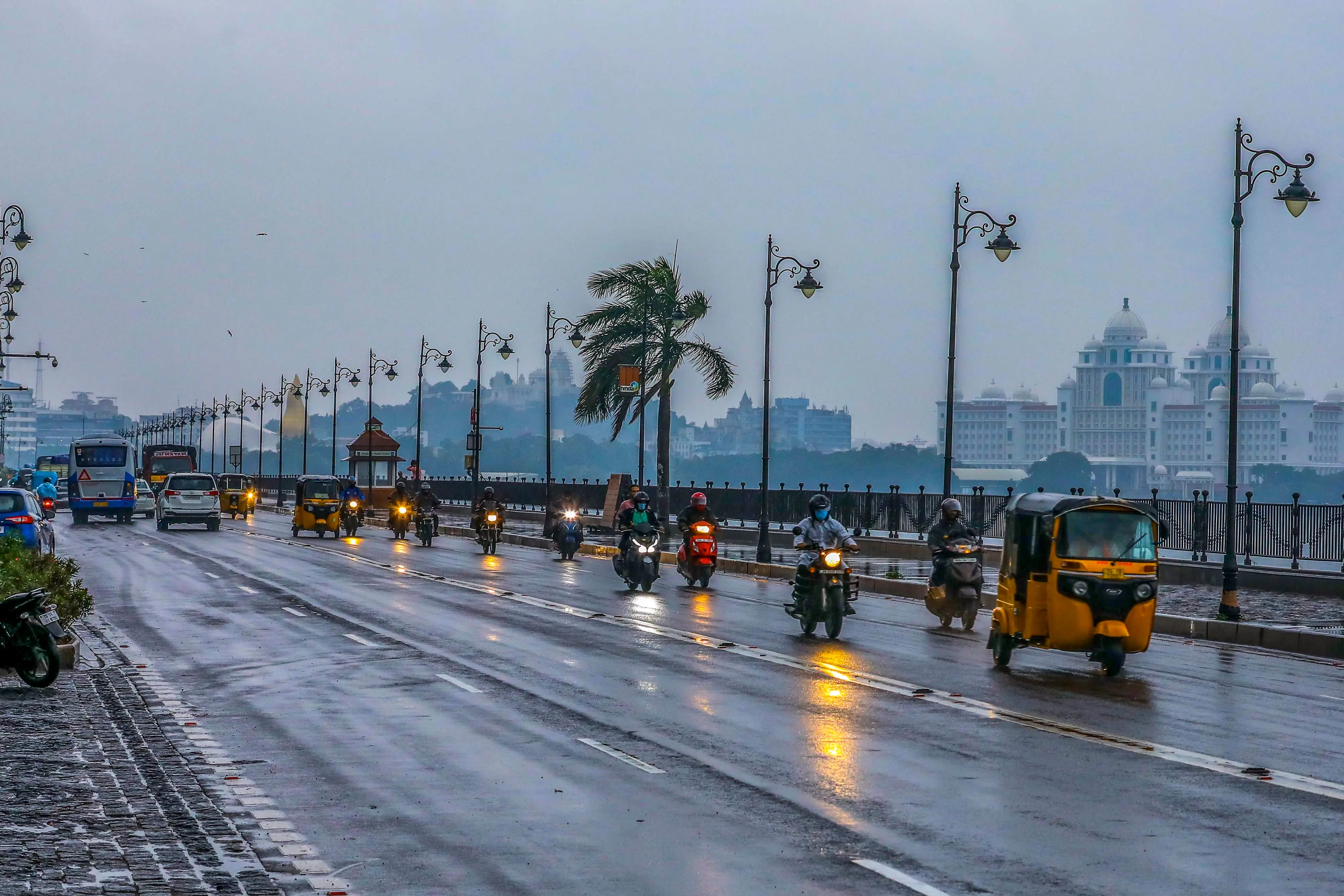 Vehicles ply on a rain-soaked road after heavy rainfall, at Tank Bund, in Hyderabad, Telangana.| Photo: PTI