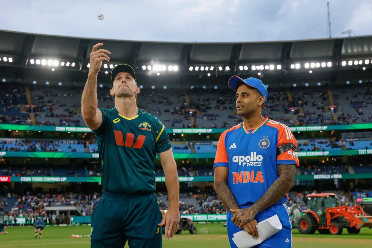 Australian skipper Mitchell Marsh flips the coin at the toss in Melbourne, as Indian captain Suryakumar Yadav looks on. | Photo: X/BCCI