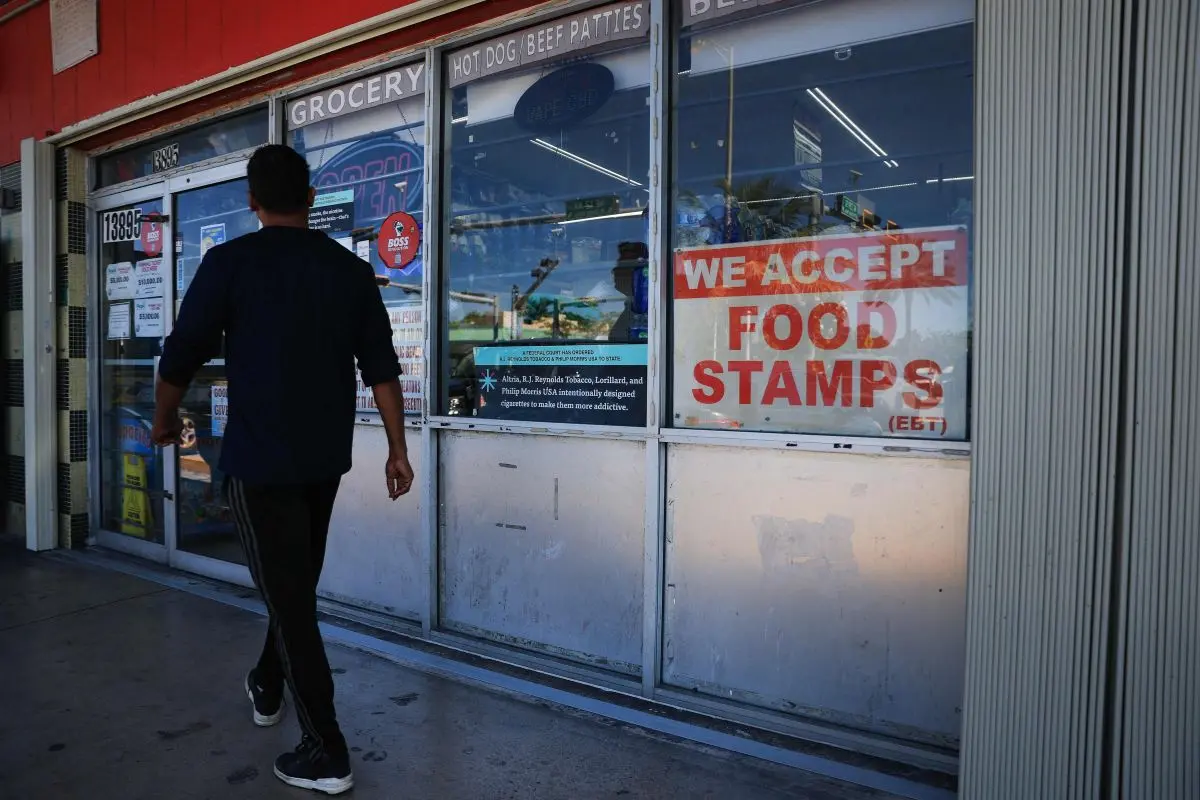 A 'We Accept Food Stamps' sign hangs in the window of a grocery store on October 31, 2025 in Miami, Florida (Photo: AFP)