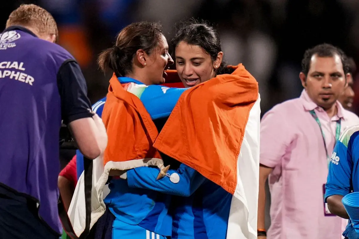 India's captain Harmanpreet Kaur, left, and vice captain Smriti Mandhana hold the Indian tricolour as they celebrate after winning the ICC Women's World Cup final ODI cricket match between India Women and South Africa Women, at the DY Patil Stadium in Navi Mumbai. | Photo: PTI
