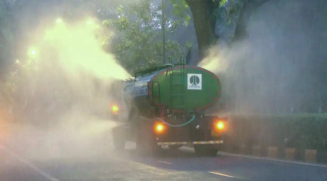 The Air Quality Index (AQI) reaches 180, falling under the 'Moderate' category, as truck-mounted water sprinklers are deployed to control pollution, in New Delhi on Saturday. | Photo: ANI
