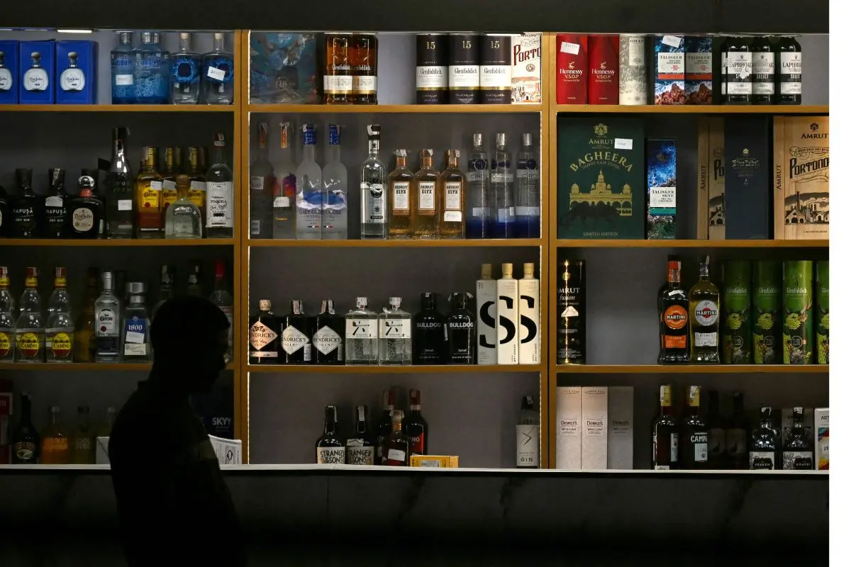 Liquor bottles are displayed at a store | AFP