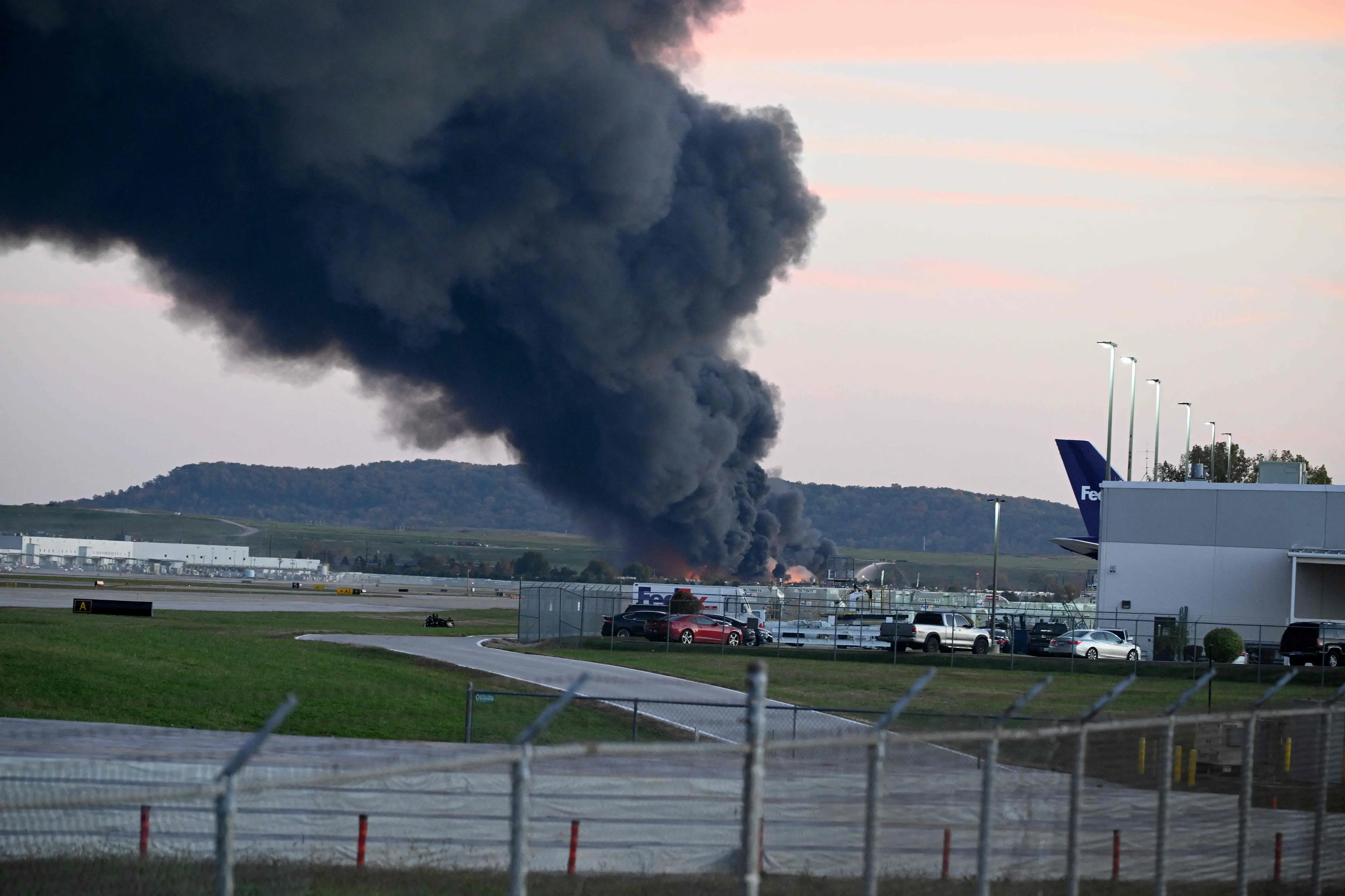 Fire and smoke mark where a UPS cargo plane crashed near Louisville Muhammad Ali International airport | Photo: Getty Images via AFP
