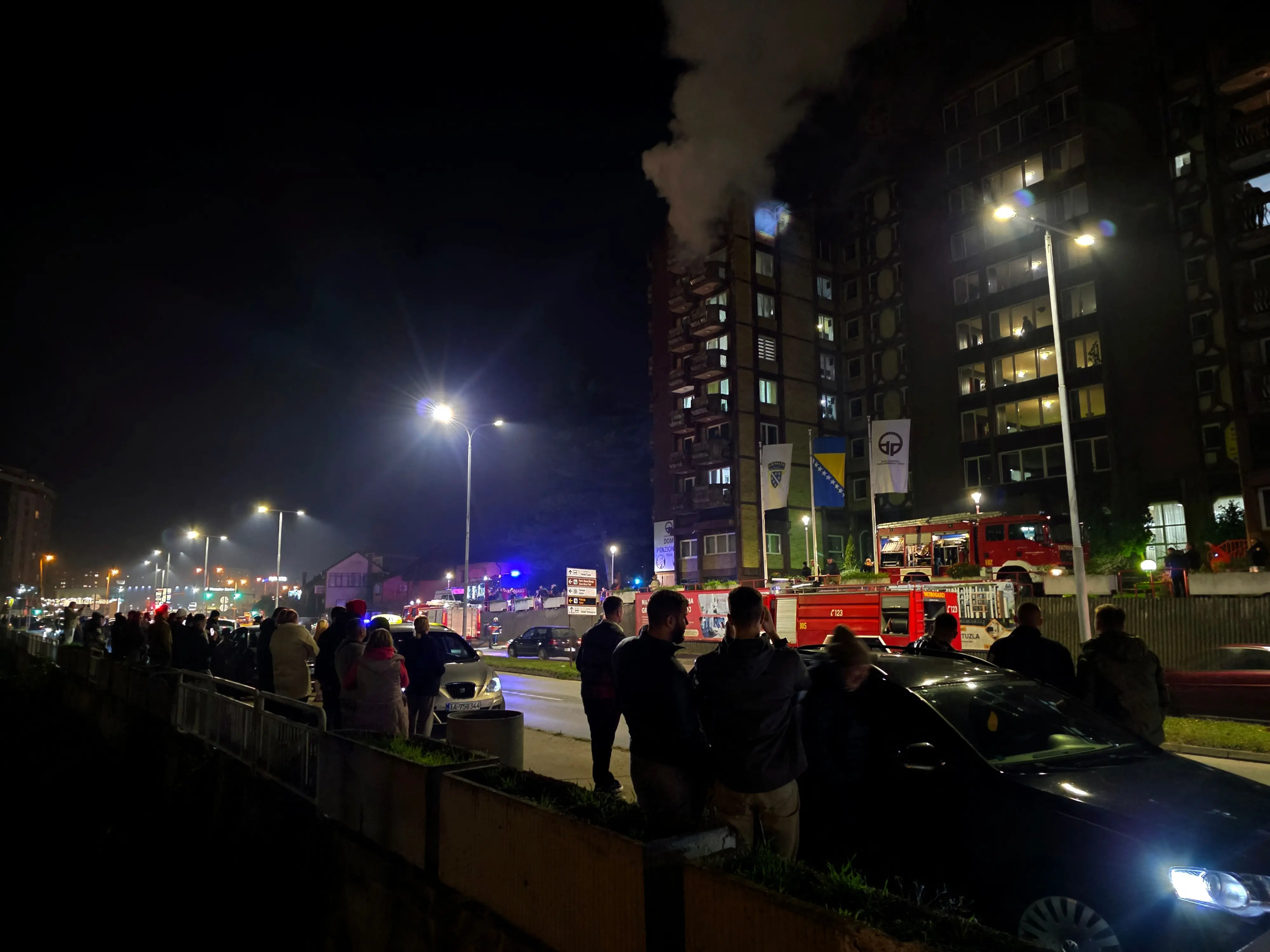 Bystanders watch the scene of a blaze after fire broke out in a nursing home, in the North-Eastern Bosnian city of Tuzla, late on November 4, 2025. | Photo: AFP