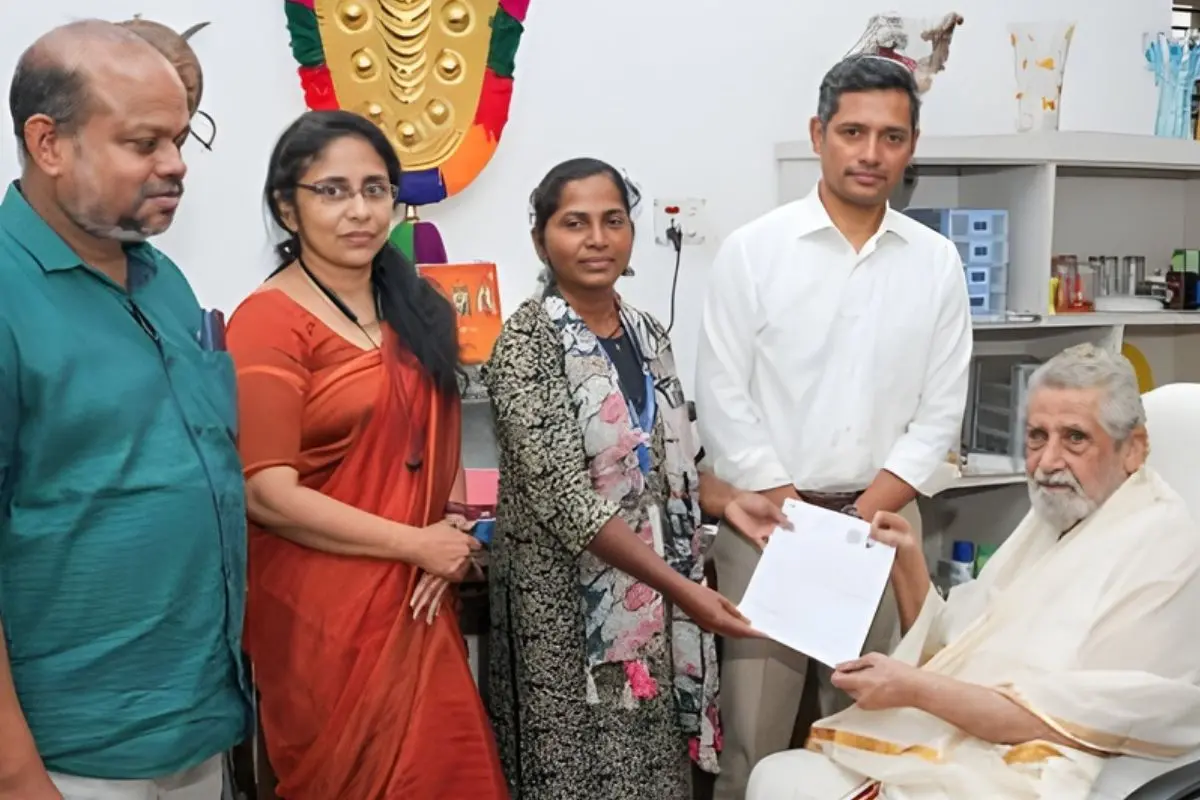 Chief Electoral Officer Rathan Kelkar, along with election officials, handed over the SIR enumeration forms to veteran actor Madhu | Photo: Mathrubhumi
