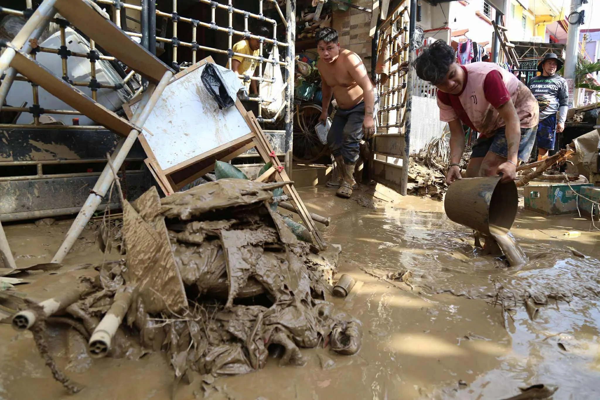 Residents clean up outside their homes after Typhoon Kalmaegi caused devastation in communities at Talisay City, Cebu province, central Philippines | AP/PTI