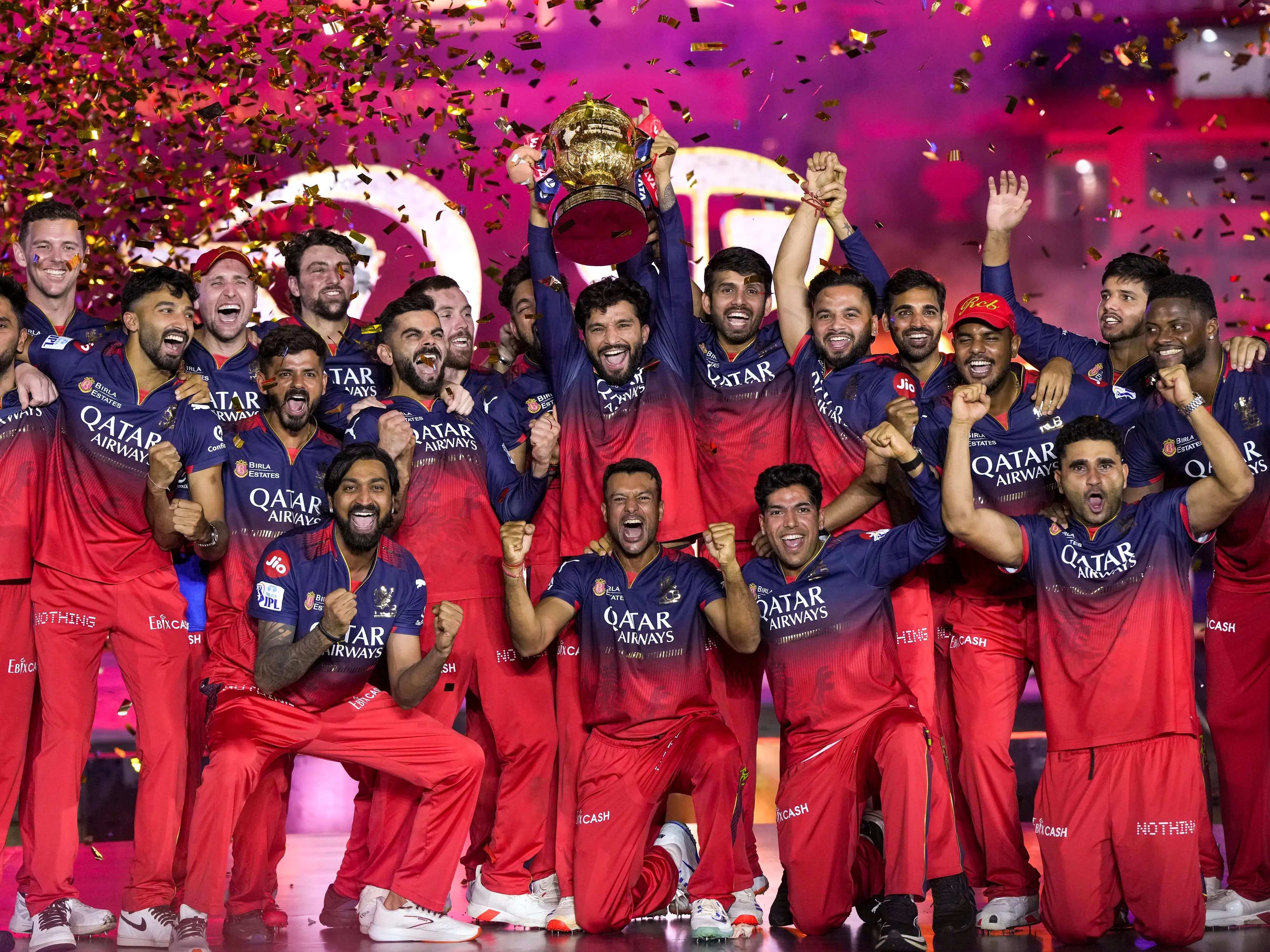 A photo showing Royal Challengers Bengaluru players lifting the coveted IPL trophy in front of a sea of red at the M Chinnaswamy Stadium. Photo: IANS