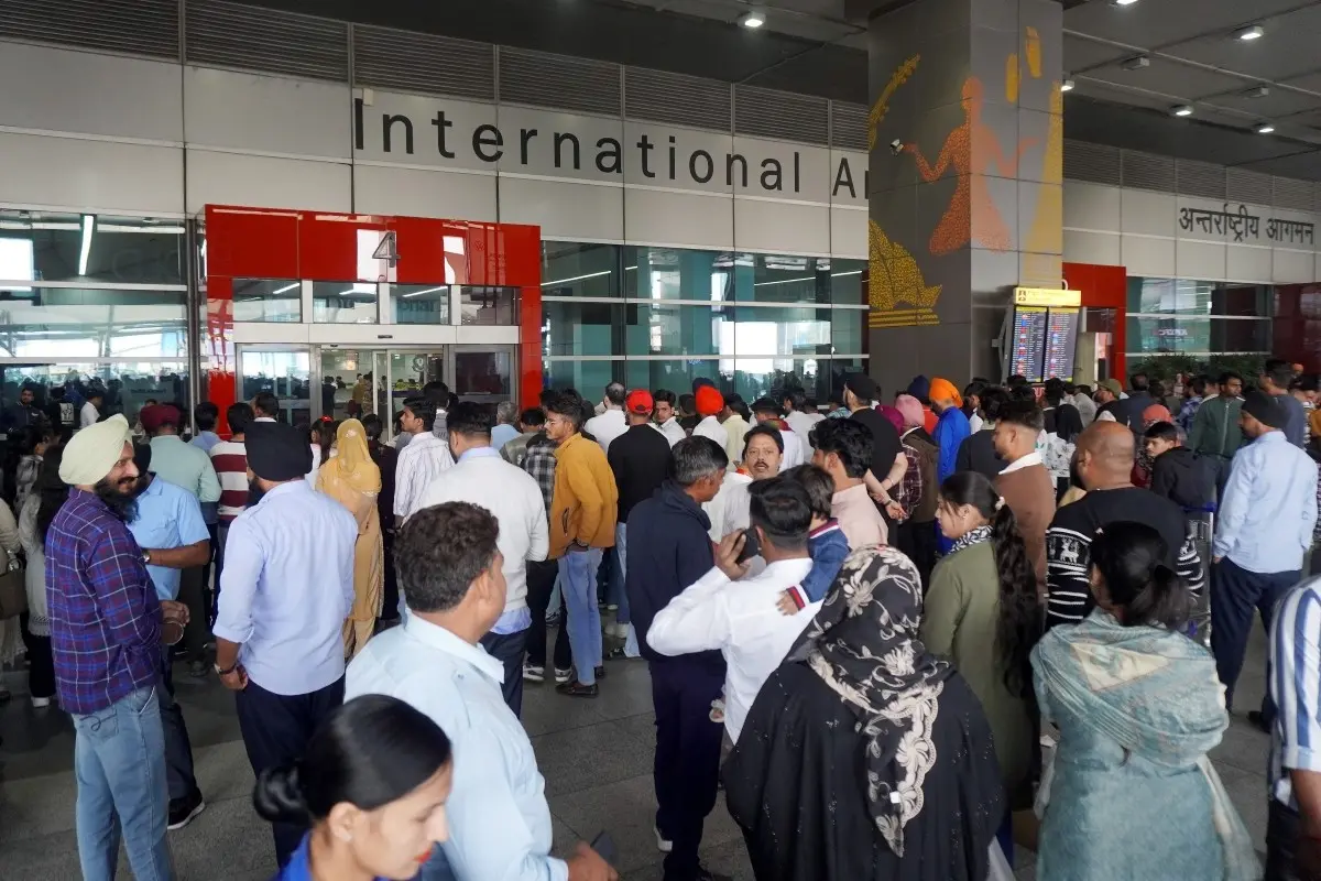 People wait outside the arrivals' exit at the Indira Gandhi International (IGI) Airport, in New Delhi