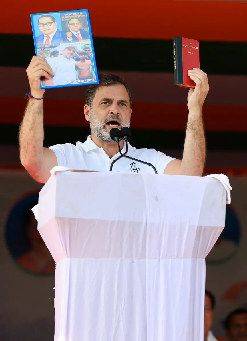 Lok Sabha Leader of Opposition Rahul Gandhi addresses an election rally, holding a picture of B.R. Ambedkar and a handbook of the Constitution in his hands at Amarpur, in Banka.| Photo: ANI