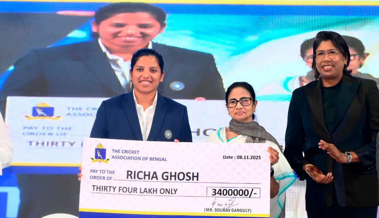 West Bengal Chief Minister Mamata Banerjee felicitates Richa Ghosh, member of the Women's ODI World Cup 2025-winning Indian cricket team, during a felicitation ceremony at Eden Gardens, in Kolkata. Former cricketer Jhulan Goswami is also seen. | Photo: PTI