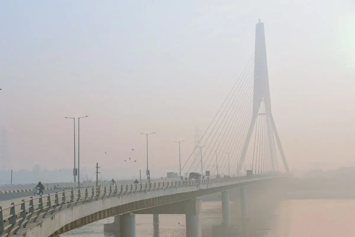 A view of the Signature Bridge covered in smog as the Air Quality Index (AQI) remain in the very poor category, in New Delhi on Monday. (ANI Photo/ Sumit)