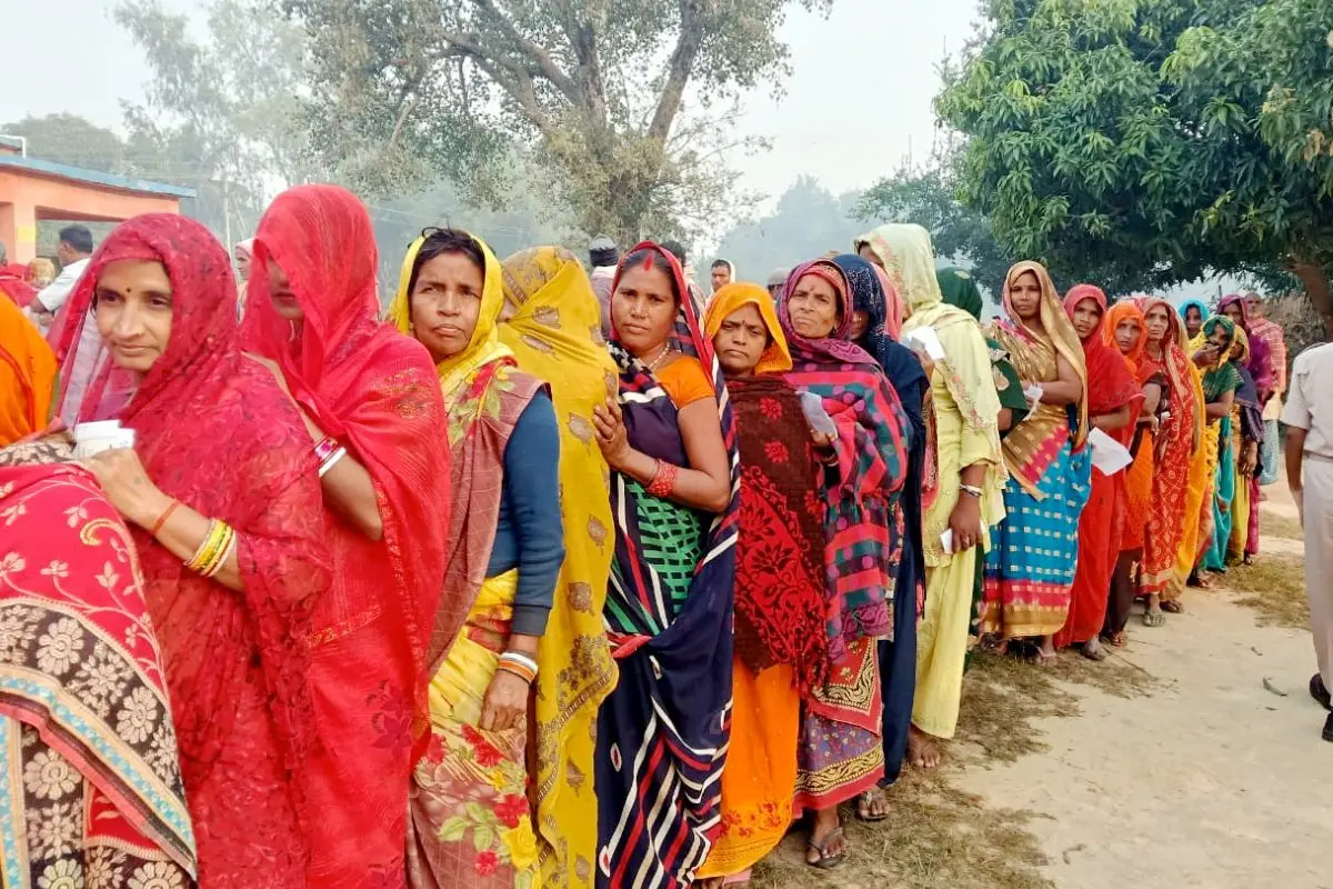 People wait in a queue to cast their votes during the second and final phase in the Bihar Assembly election, in Madhubani. (PTI Photo)