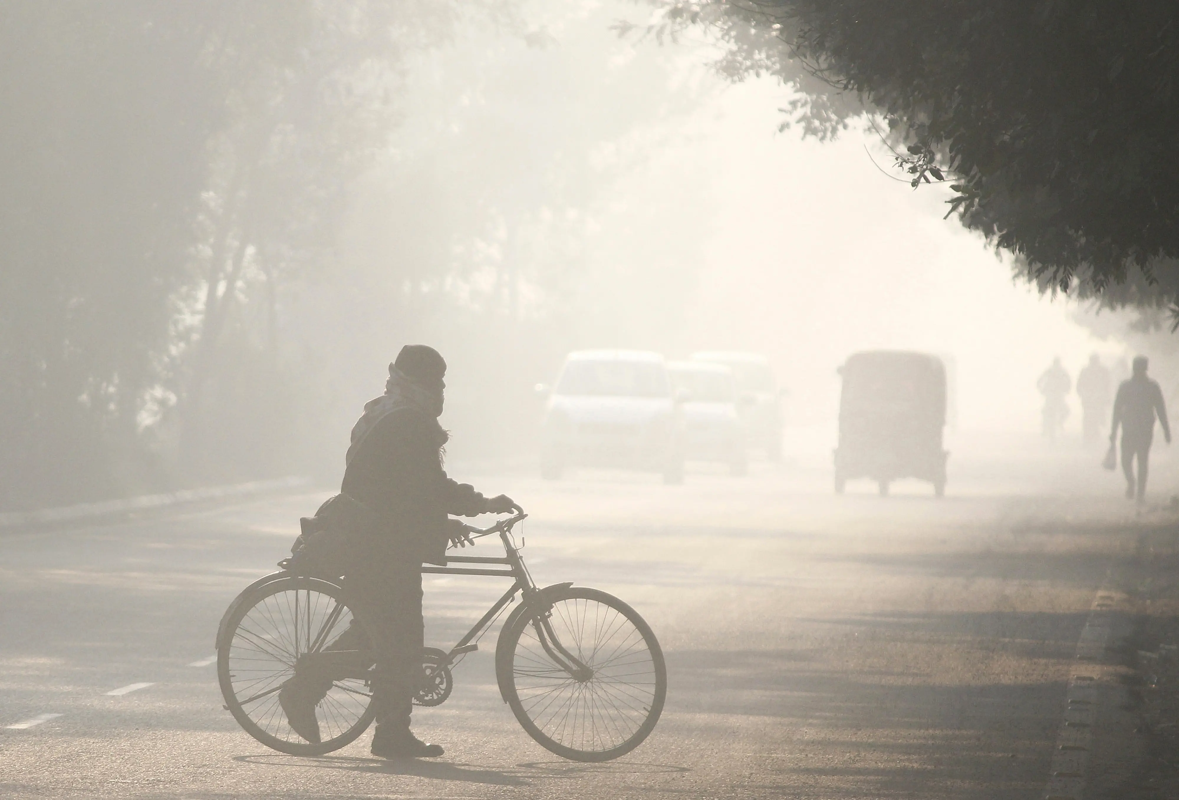 Commuters make their way amid low visibility as air quality continues to deteriorate in Delhi-NCR, in Gurugram | PTI