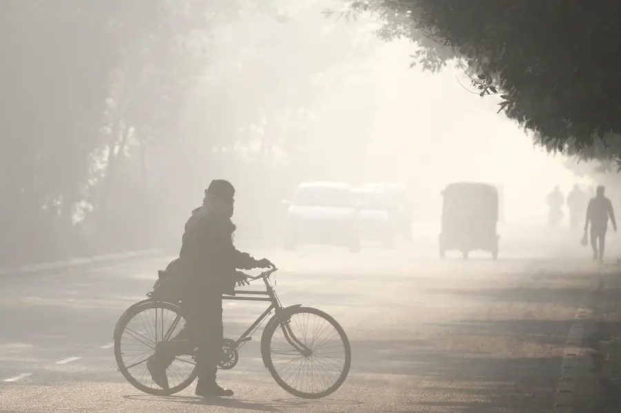 Commuters make their way amid low visibility as air quality continues to deteriorate in Delhi-NCR