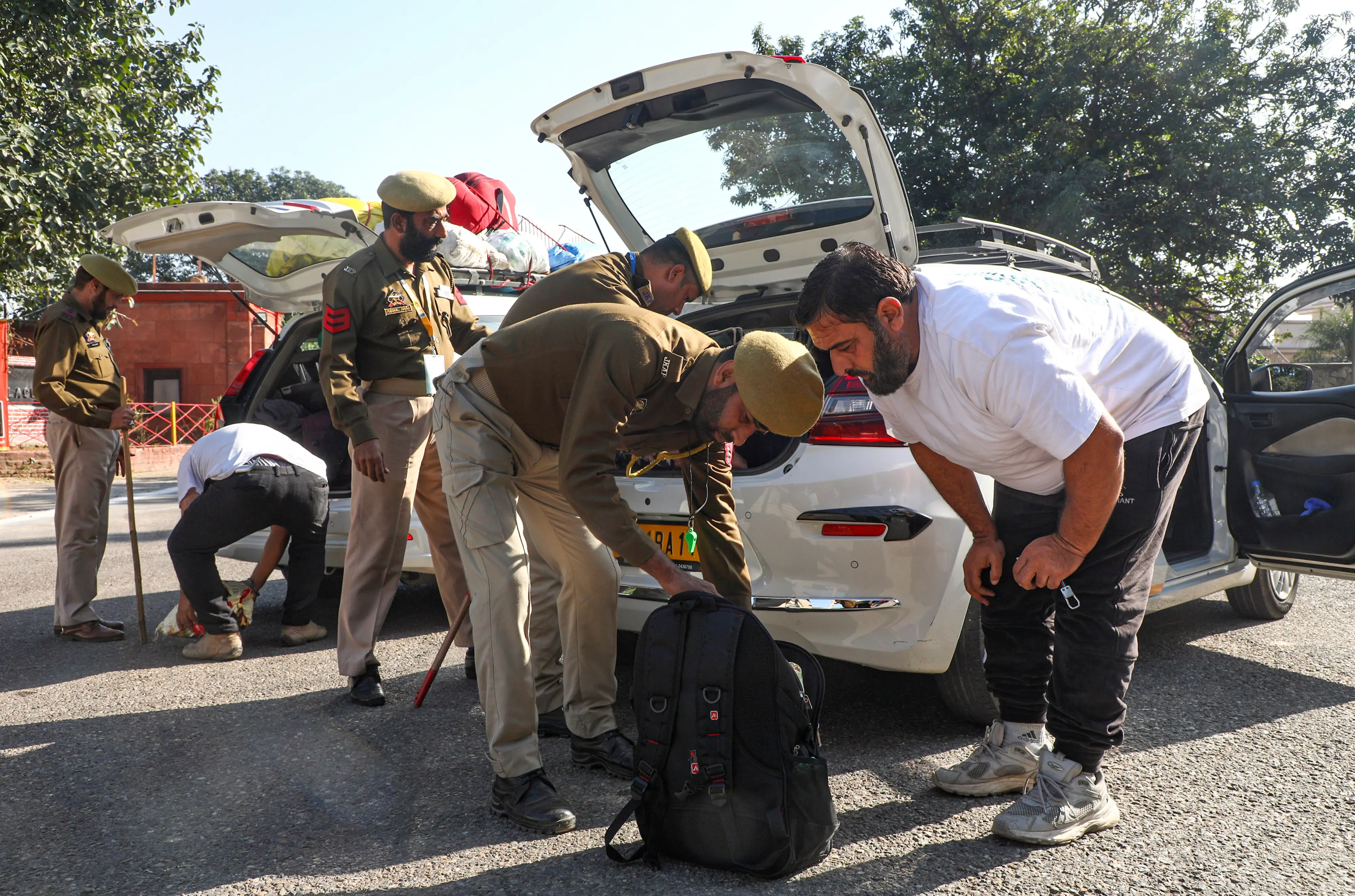 Security personnel inspect commuters amid high alert in the aftermath of a blast near the Red Fort, on Jammu-Srinagar National Highway. | Photo: PTI