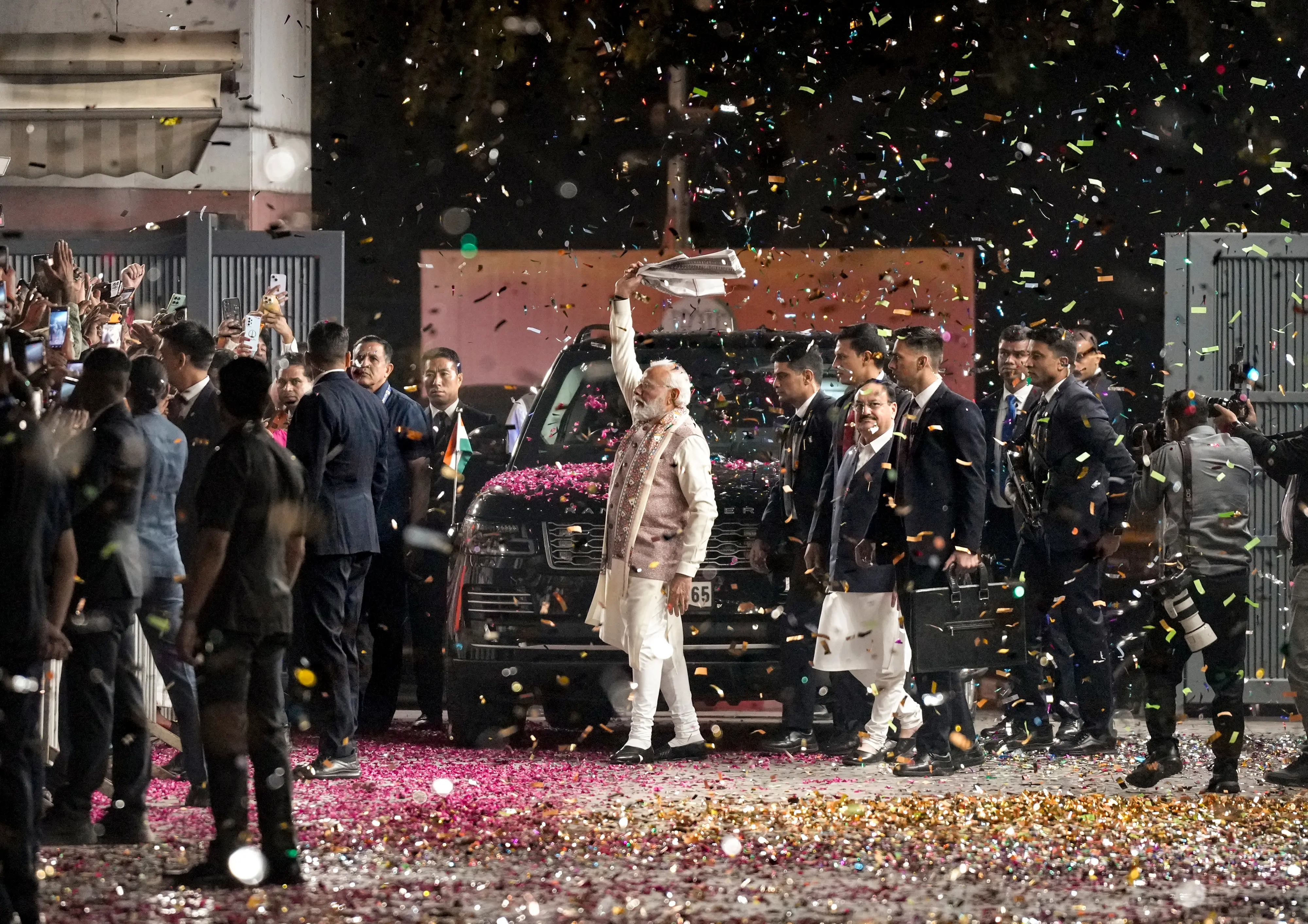 Prime Minister Narendra Modi greets the gathering as he arrives during the celebration of NDA's victory in the Bihar Assembly elections, at BJP headquarters, in New Delhi. | Photo: PTI
