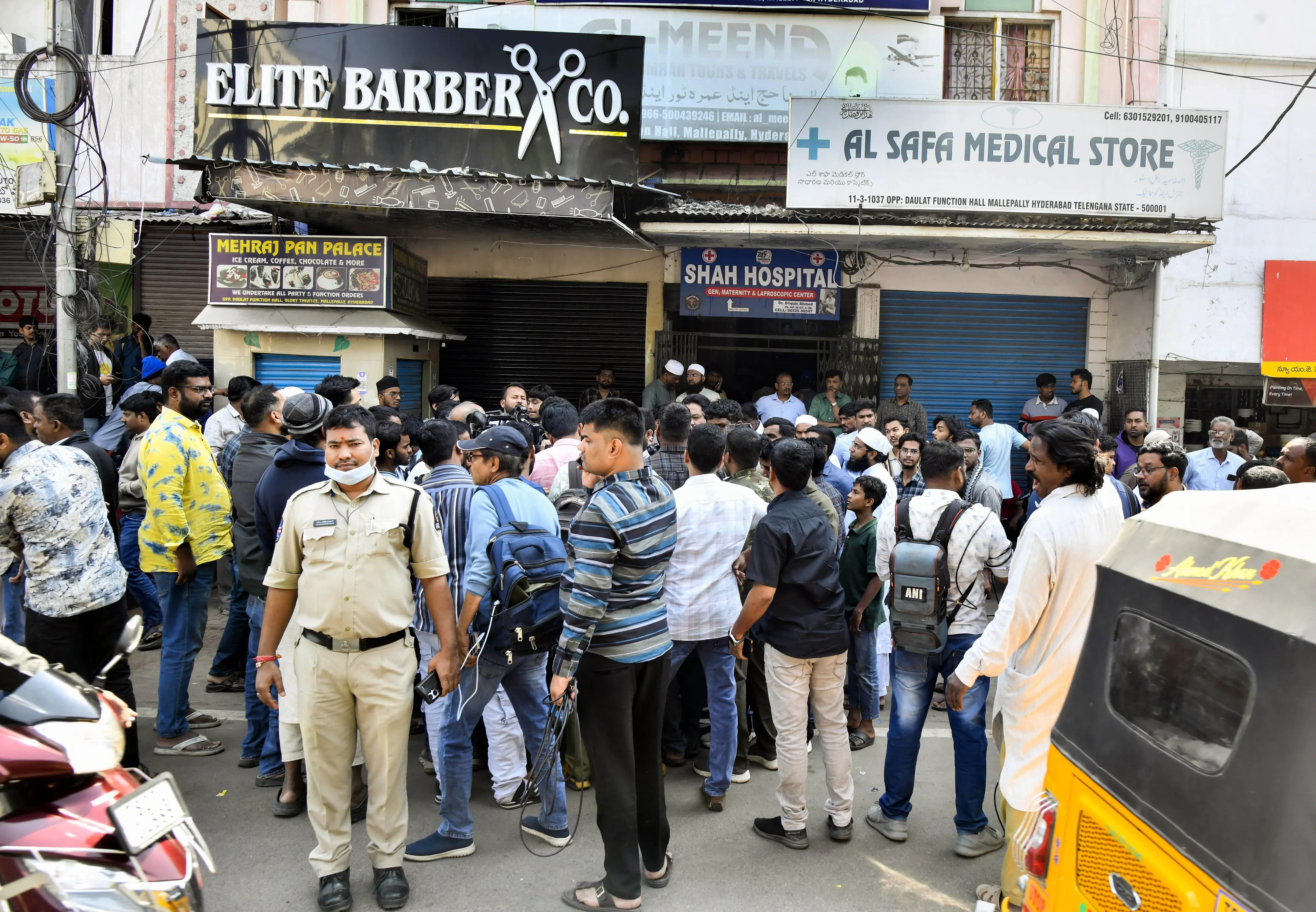 Media and Police personnel seen outside the Al Meena Hajj and Umrah Tours and Travels office in Mallepally, following the reports of Hyderabadi pilgrims travelling for Umrah being involved in an accident near Medina, in Hyderabad on Monday.| Photo: ANI