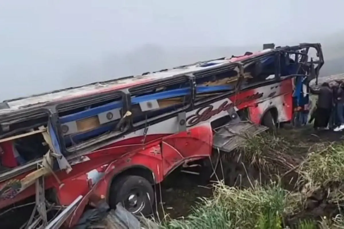 The wrecked bus lies crumpled in the ravine as rescuers search through the debris after the fatal plunge in central Ecuador. Photo: X