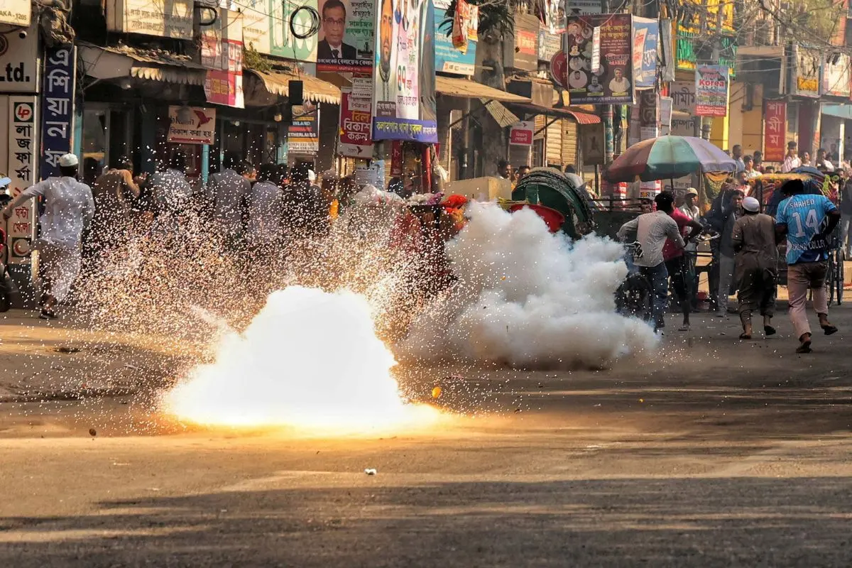 People run past a sound grenade fired by police to disperse demonstrators, ahead of the verdict on cases against the ousted Prime Minister Sheikh Hasina (Photo: ANI)