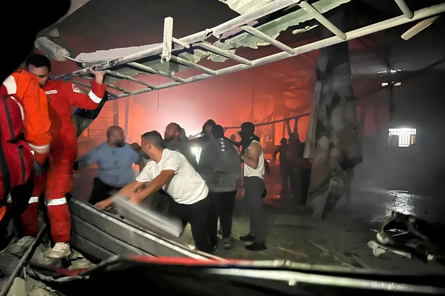 Rescuers search for survivors under rubble at the site of an Israeli drone attack that targeted the Palestinian refugees camp