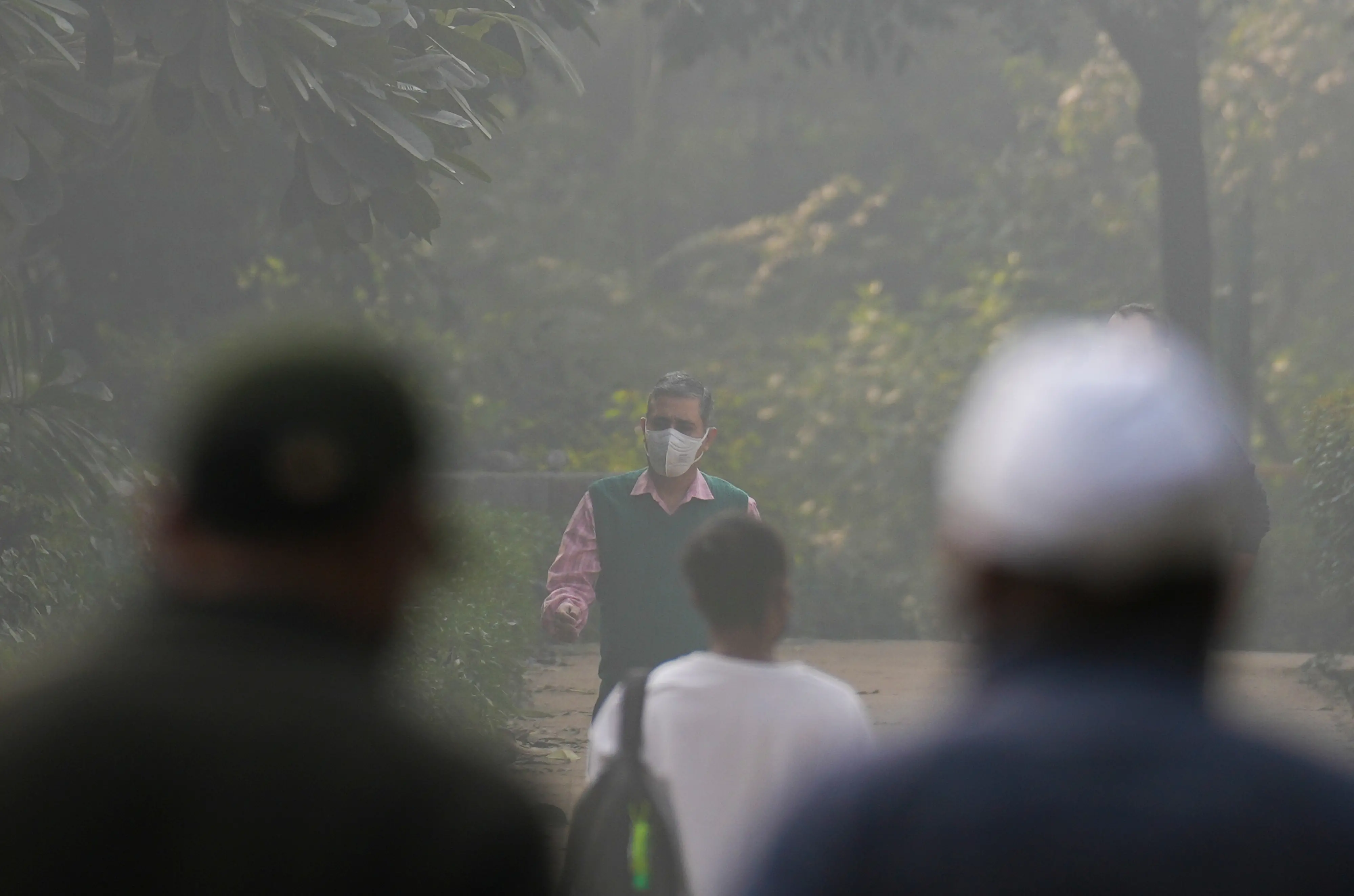 People walk at Lodhi Garden amid morning smog as air quality remains in the 'poor' category, in New Delhi, Wednesday, Nov. 19, 2025.| Photo: PTI