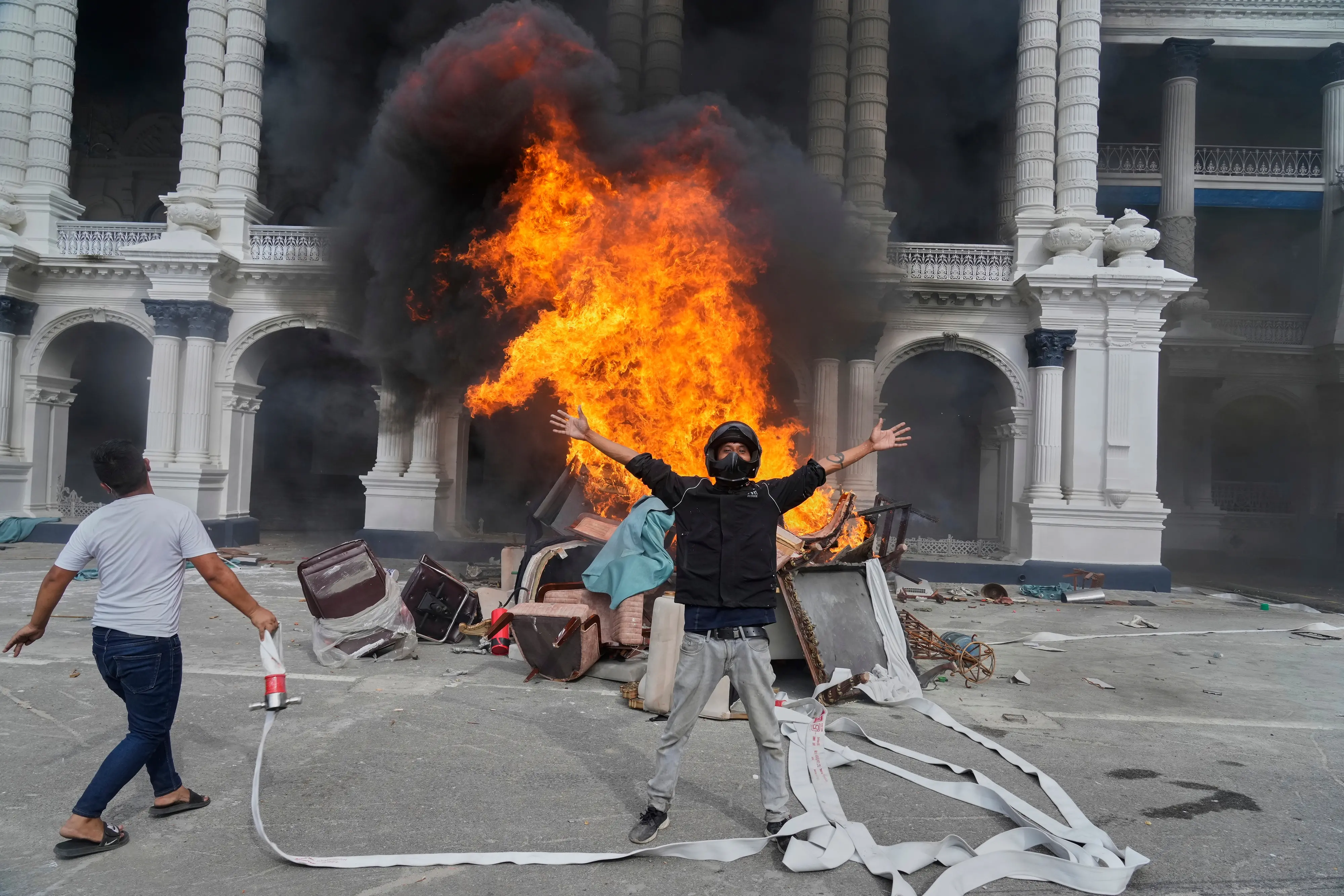 Protesters celebrate at the Singha Durbar, the seat of Nepal's government's various ministries and offices, after it was set on fire during a protest against social media ban and corruption in Kathmandu, Nepal, Tuesday, Sept. 9, 2025.| Photo: AP