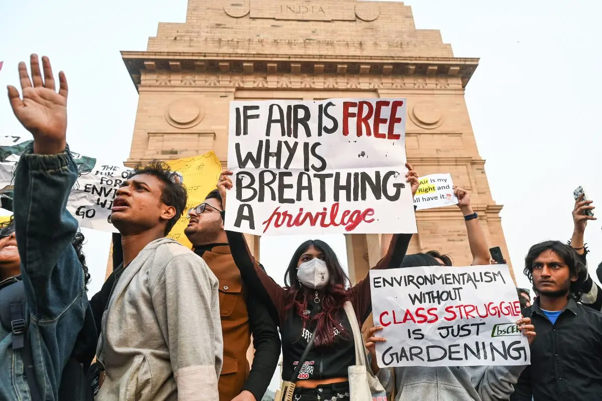 People stage a protest against rising air pollution in Delhi NCR at India Gate, in New Delhi on Sunday (Photo: ANI)