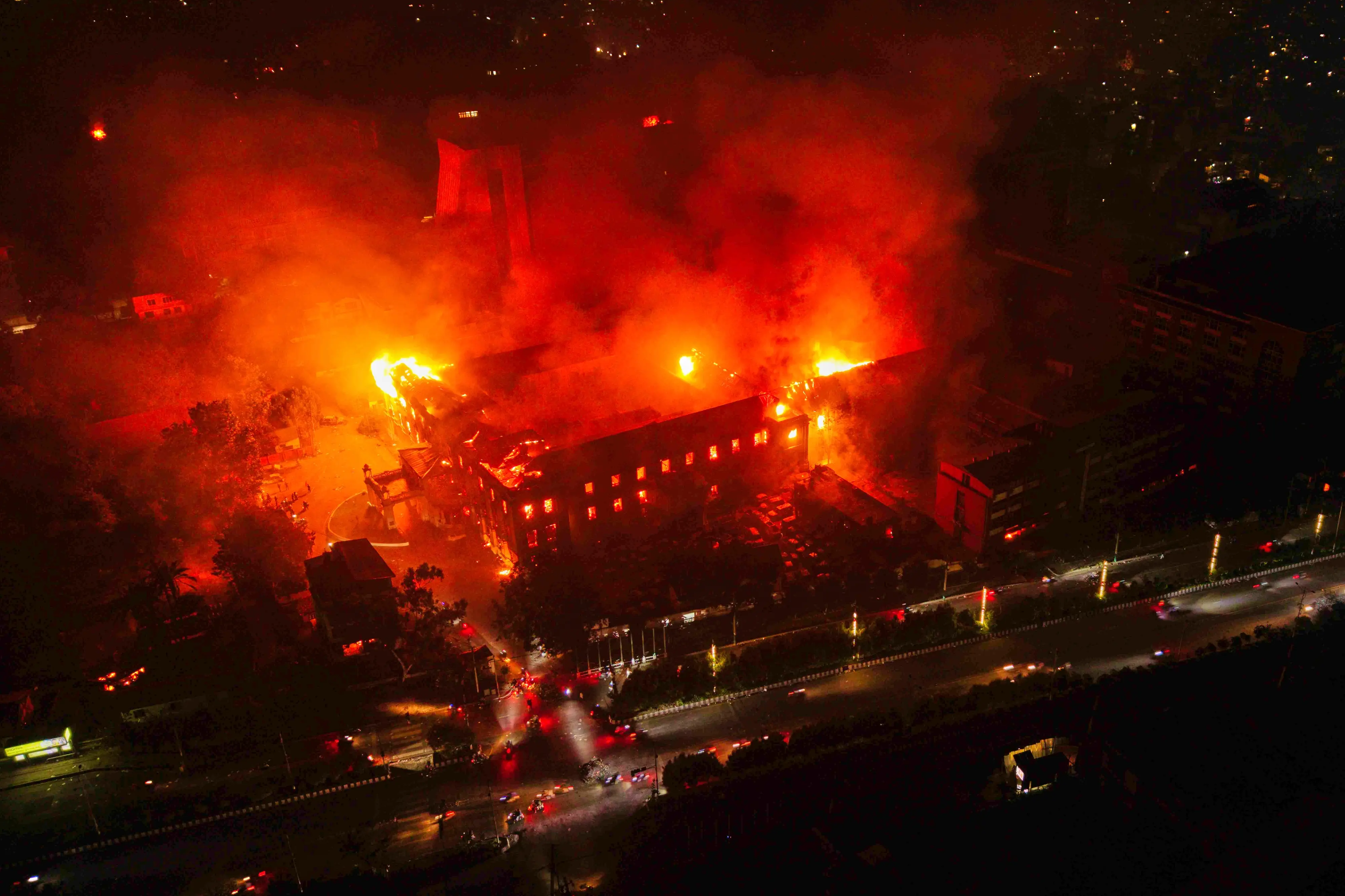 Flames come out from the parliament building after it was set on fire by protesters during a protest against social media ban and corruption in Kathmandu, Nepal. | Photo: AFP
