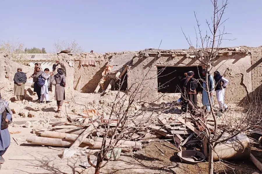 Locals inspect the site of a cross-border attack by the Pakistani army in Afghanistan's eastern Paktika province