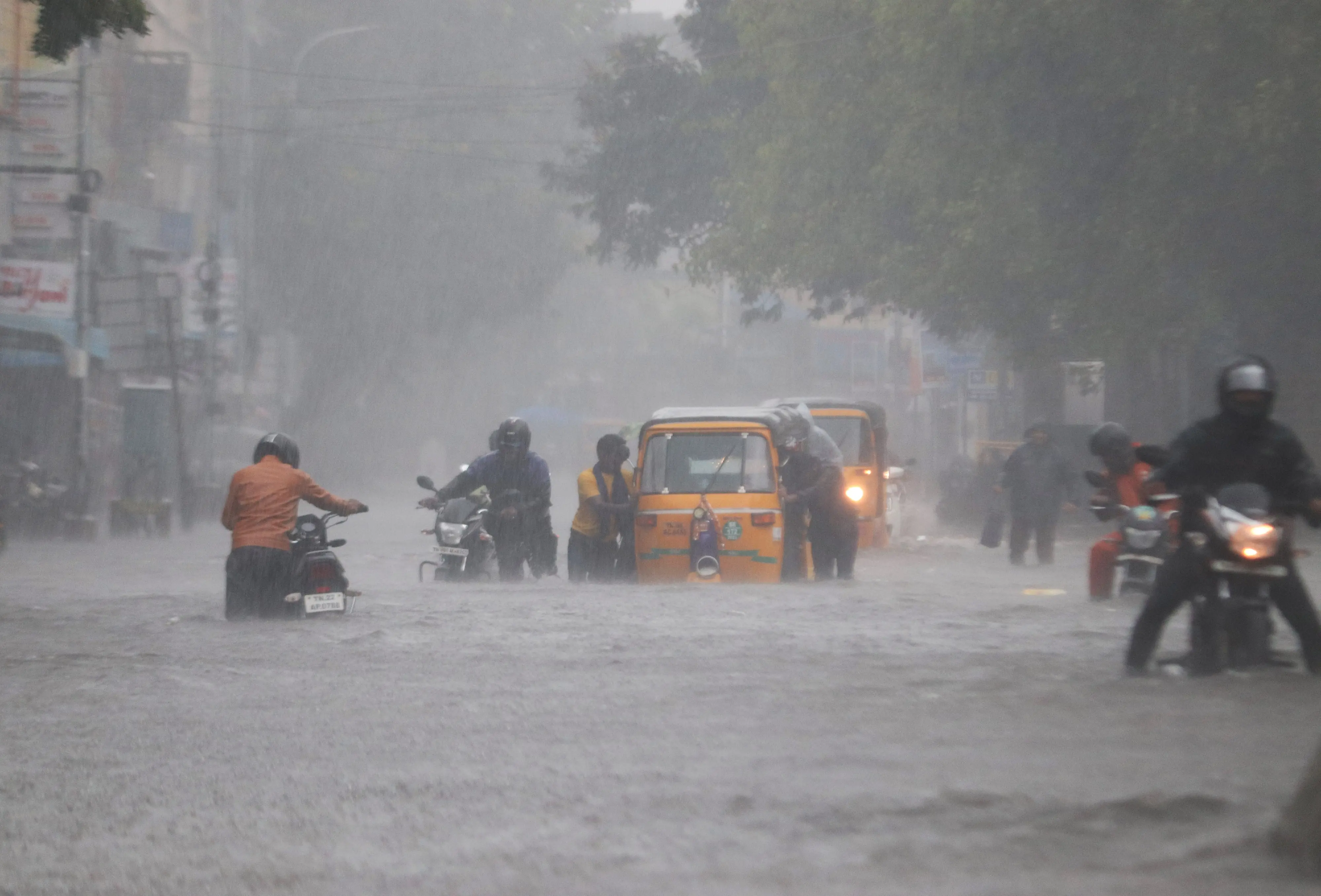Commuters wade through a waterlogged road following heavy rainfall triggered by Cyclone Fengal, in Chennai on Nov 2024. | File image: ANI