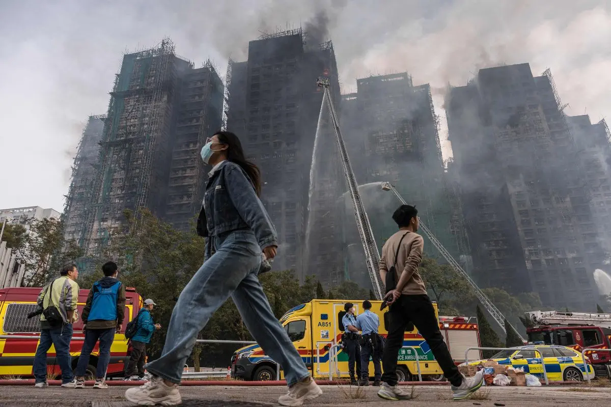 Smoke rises from apartments after a major fire swept through several blocks at the Wang Fuk Court residential estate in Hong Kong's Tai Po district. (Photo by Dale DE LA REY / AFP)