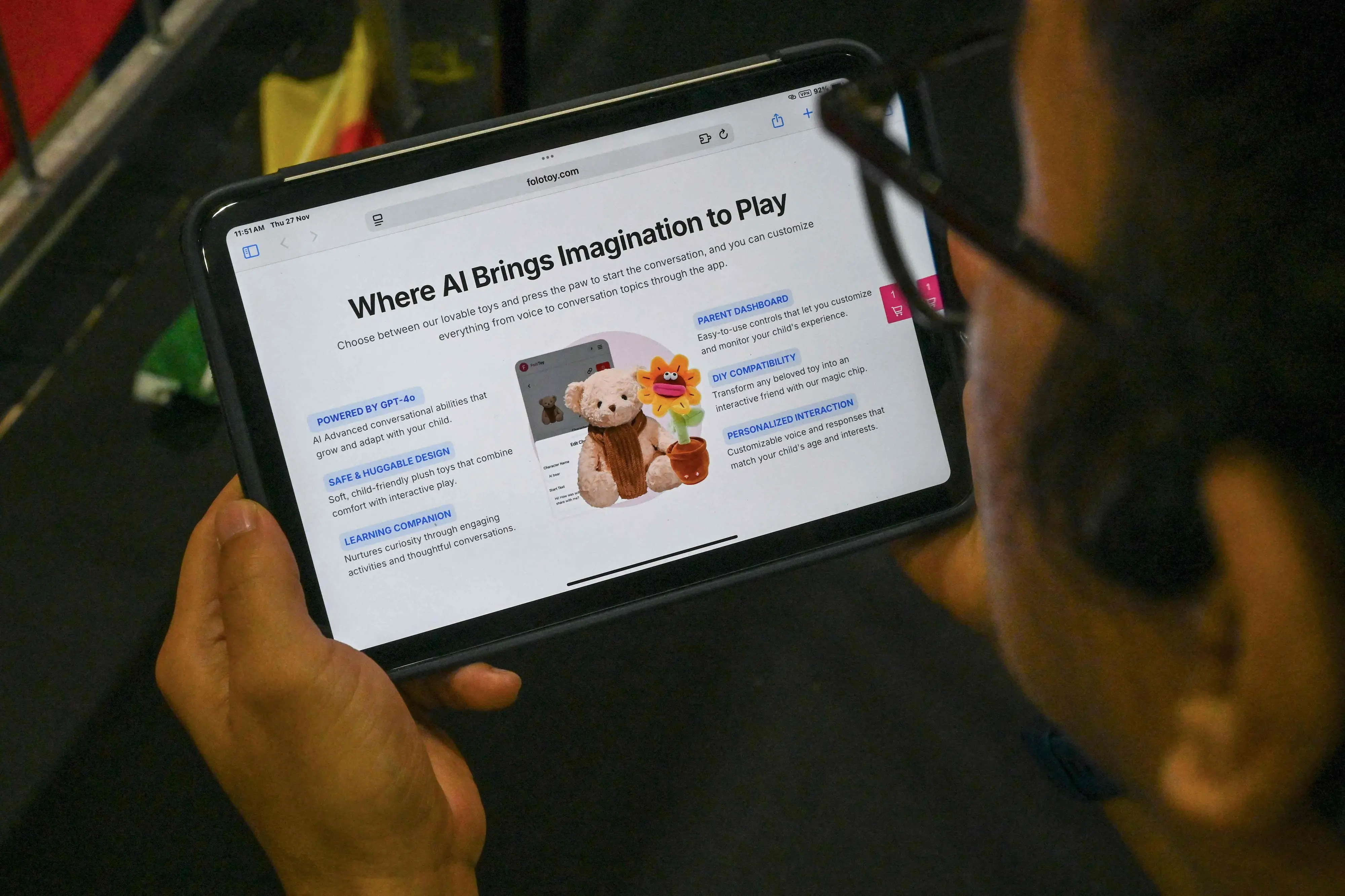 A person looks at a screen displaying a website selling a Singapore-made teddy bear equipped with AI in Singapore | AFP