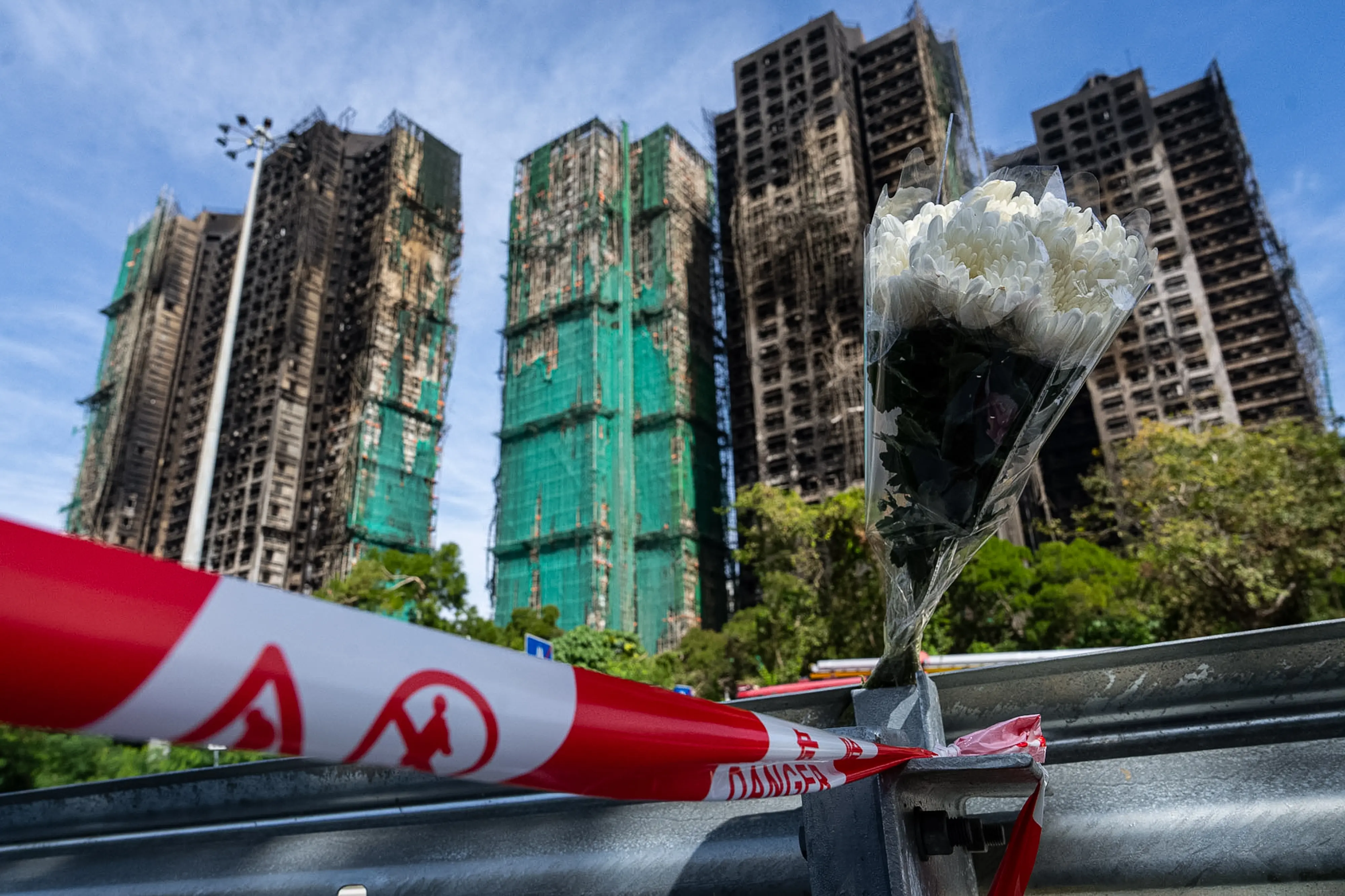 A bouquet of flower sits near the fire scene at Wang Fuk Court, a residential estate in the Tai Po district of Hong Kong's New Territories | Photo: AP
