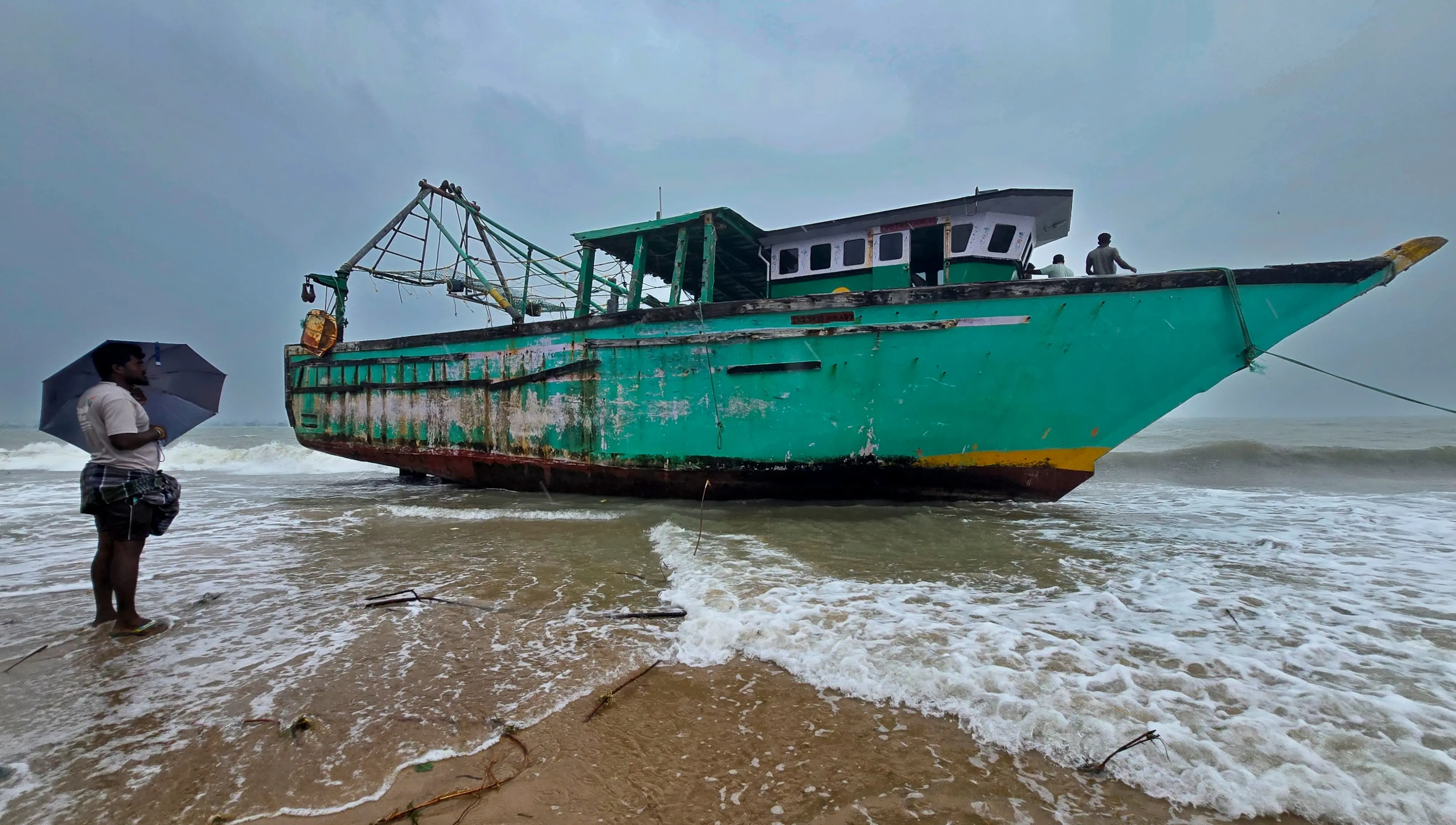 A mechanised fishing boat is anchored on a beach amid gusty winds caused by the incoming Cyclone Ditwah, in Rameswaram, Friday, Nov. 28, 2025. | Photo: PTI