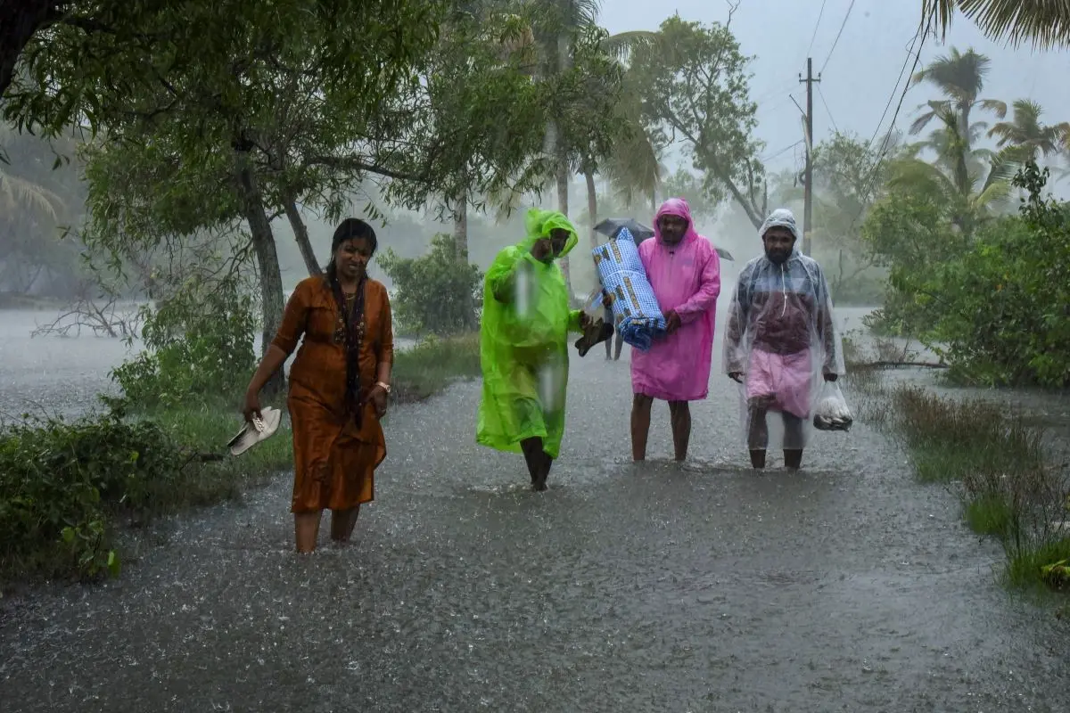 File photo | People wade through a flooded road