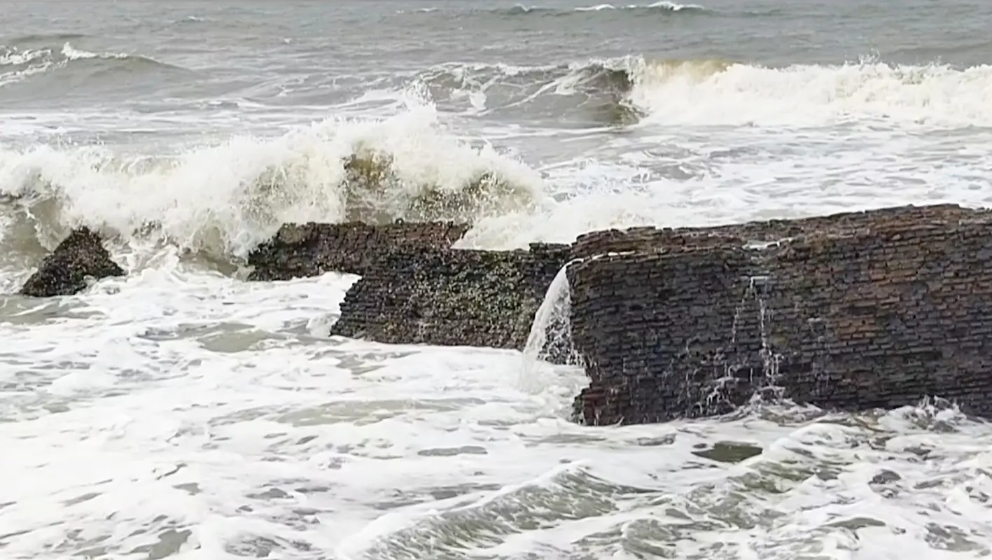 Sea waves lash against a damaged brick structure along the coast as rough conditions prevail due to Cyclone Ditwah, in Mayiladuthurai, Tamil Nadu