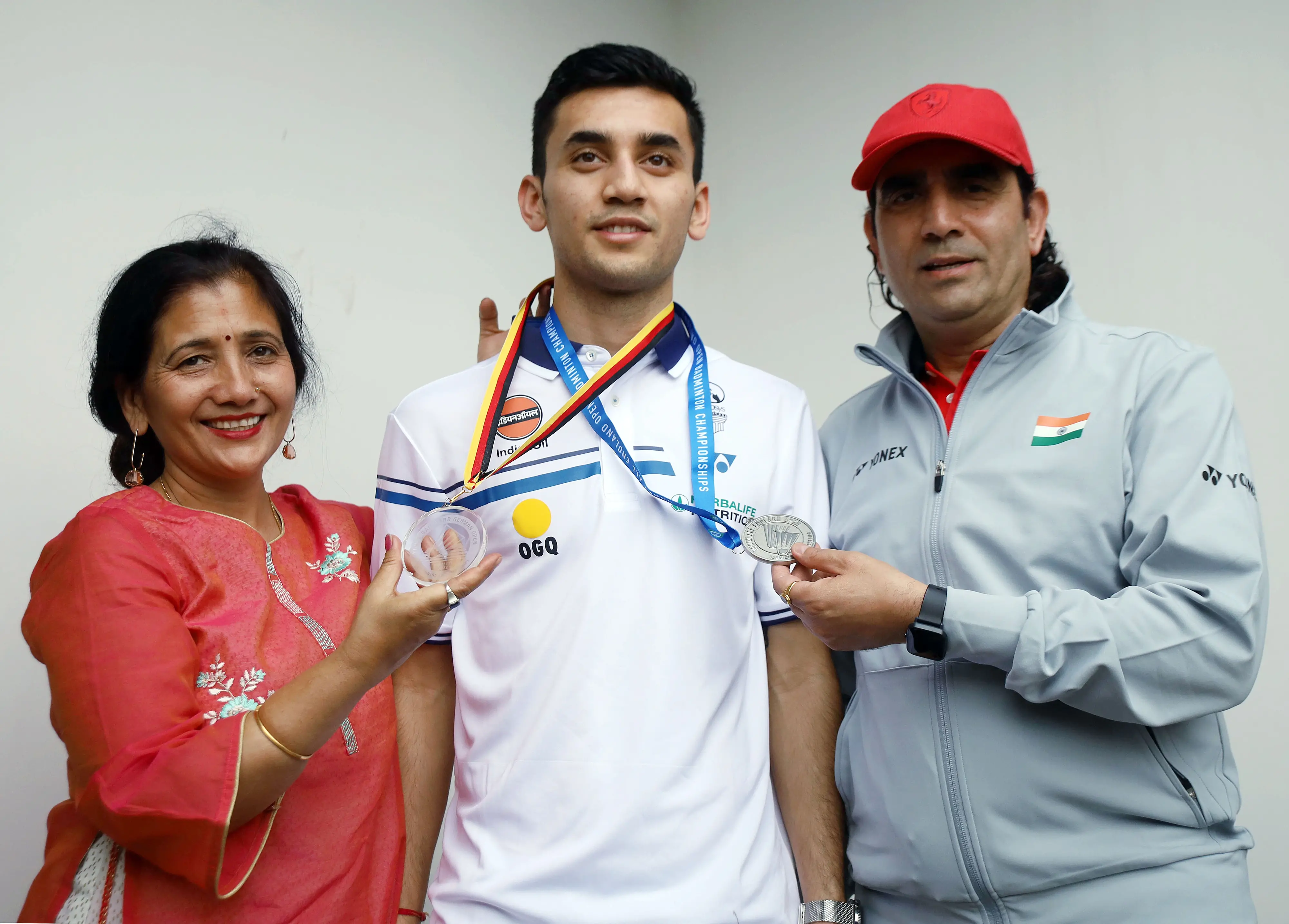 Lakshya Sen poses for a picture with his parents at a press conference I ANI